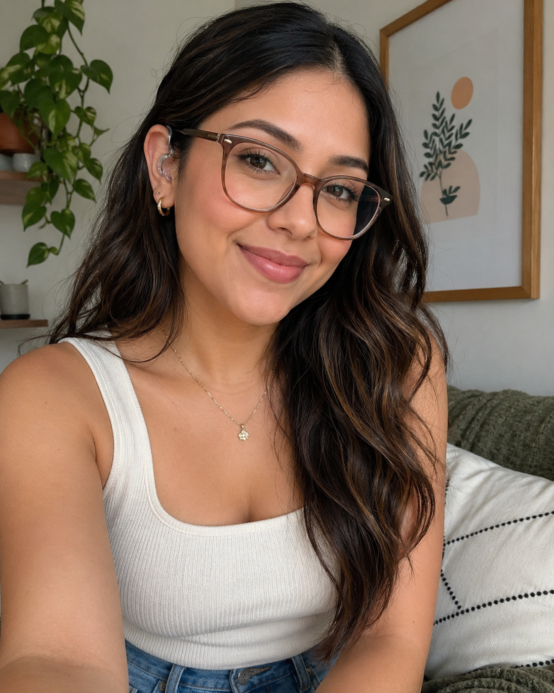 Young Hispanic female with white halter top on, wearing brown glasses and hearing aides.
