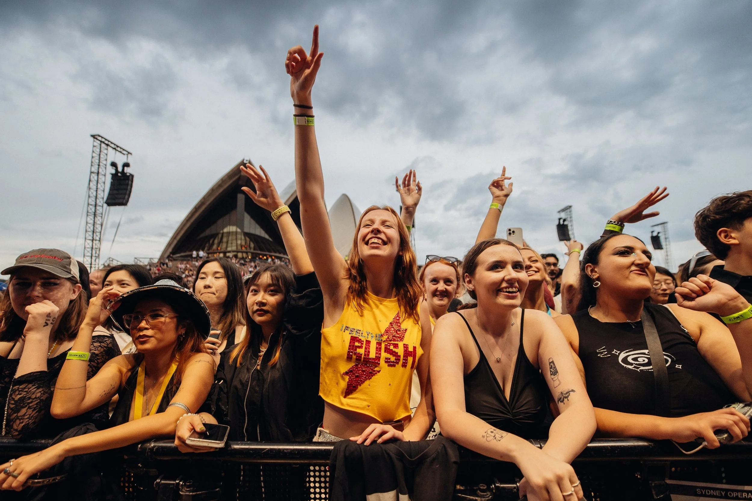 crowd of people with their hands up at a music festival