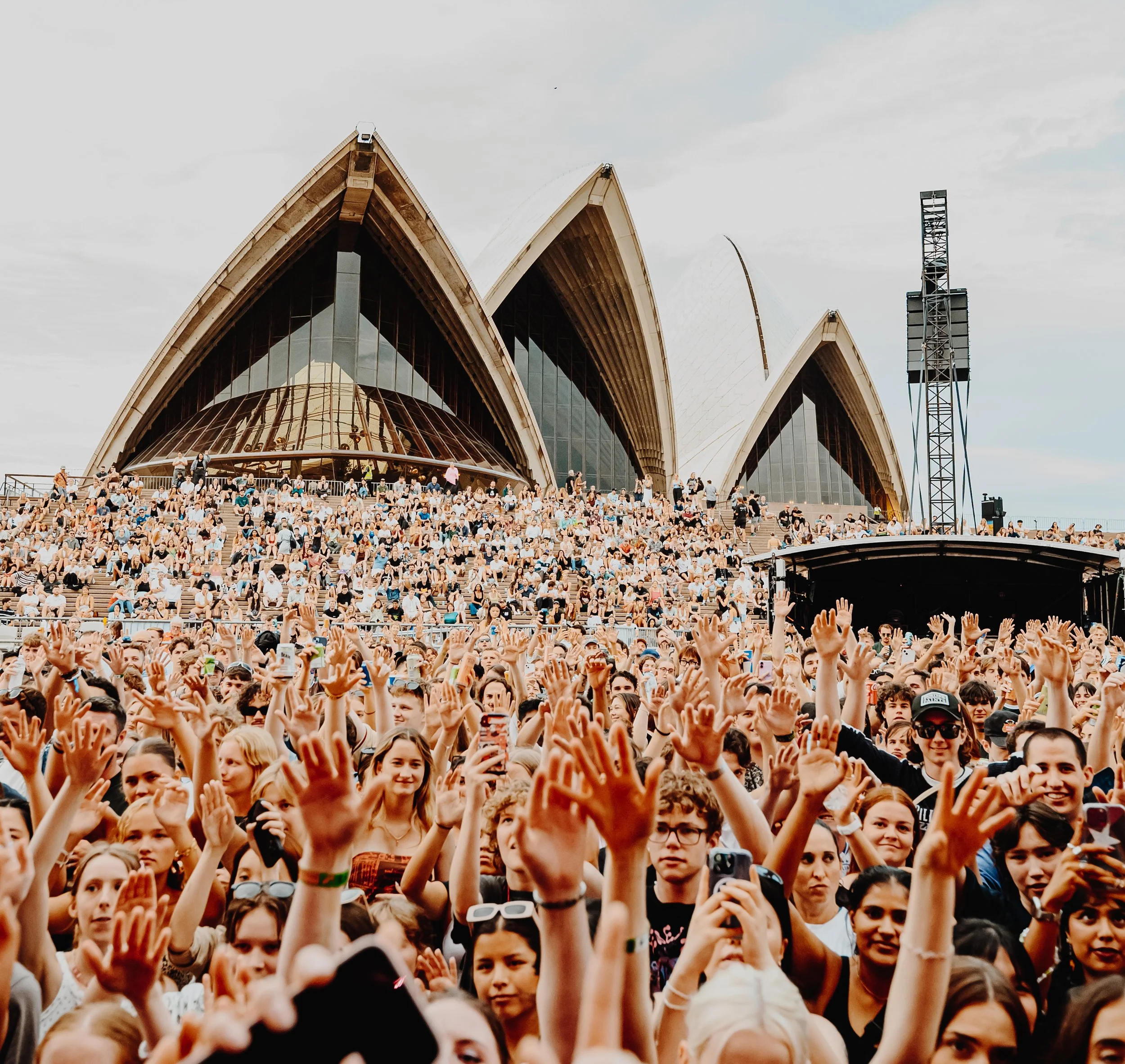 Crowd of people in front of sydney opera house.