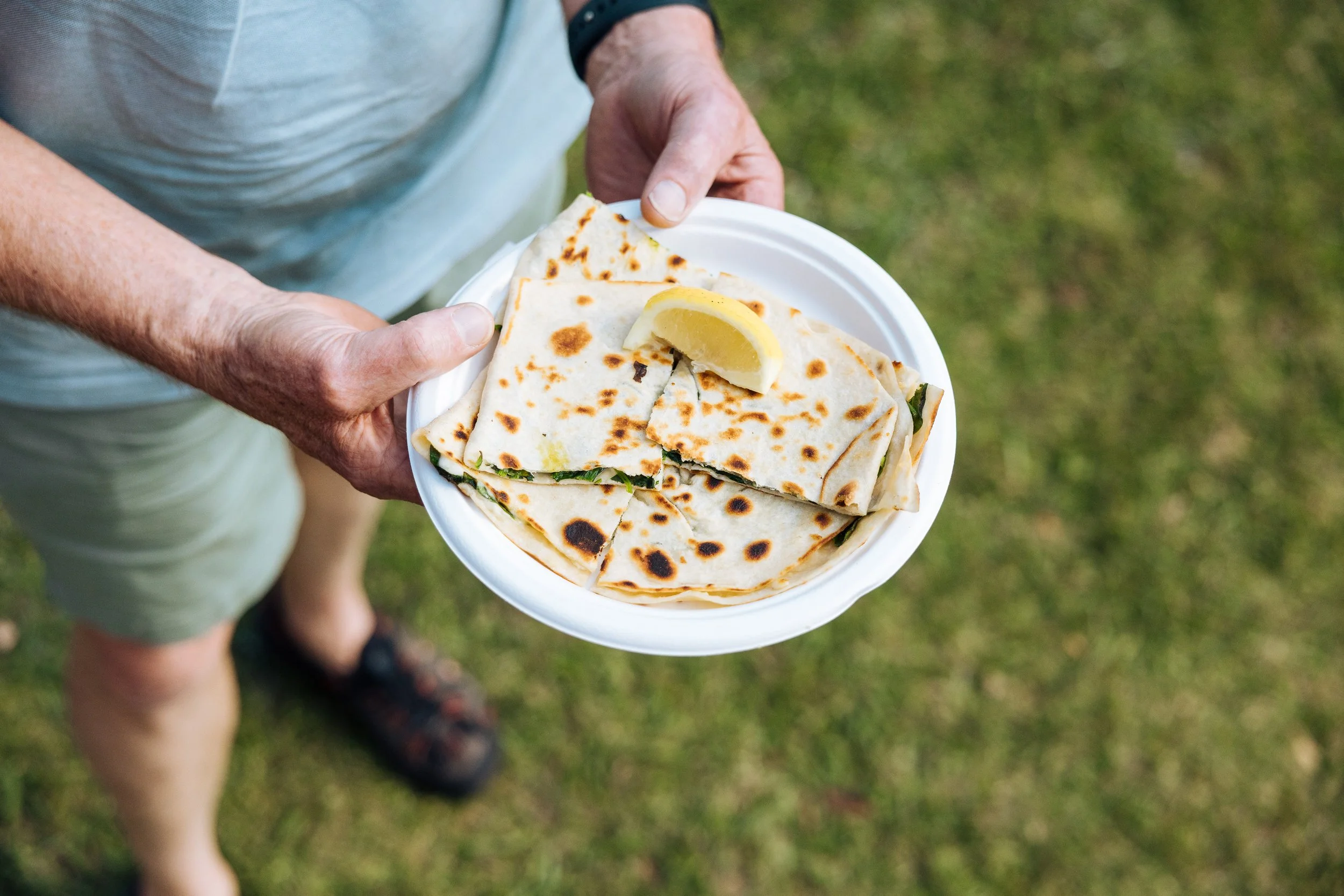 Man holding plate of gozleme.