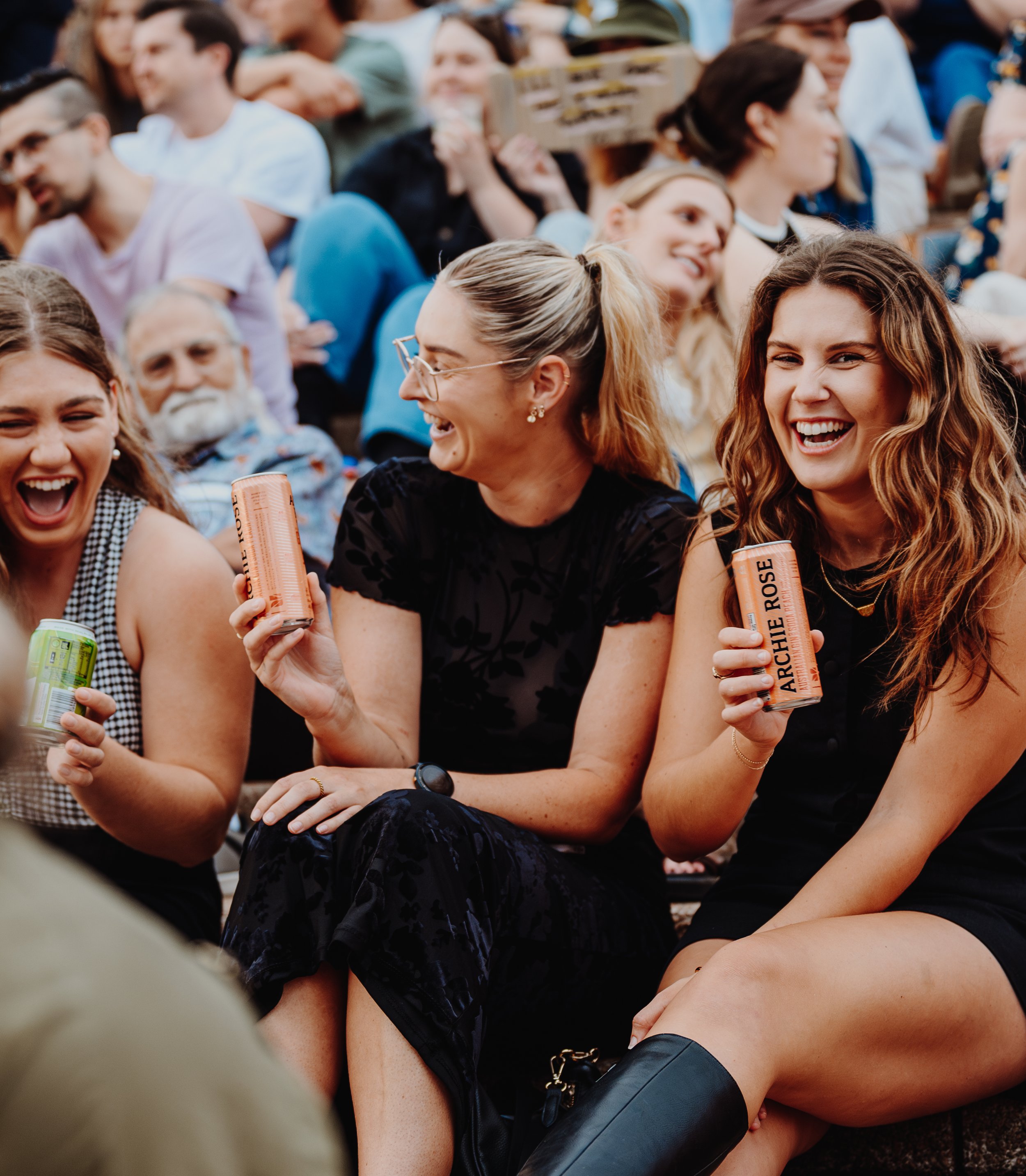 Crowd of girls holding canned drinks 