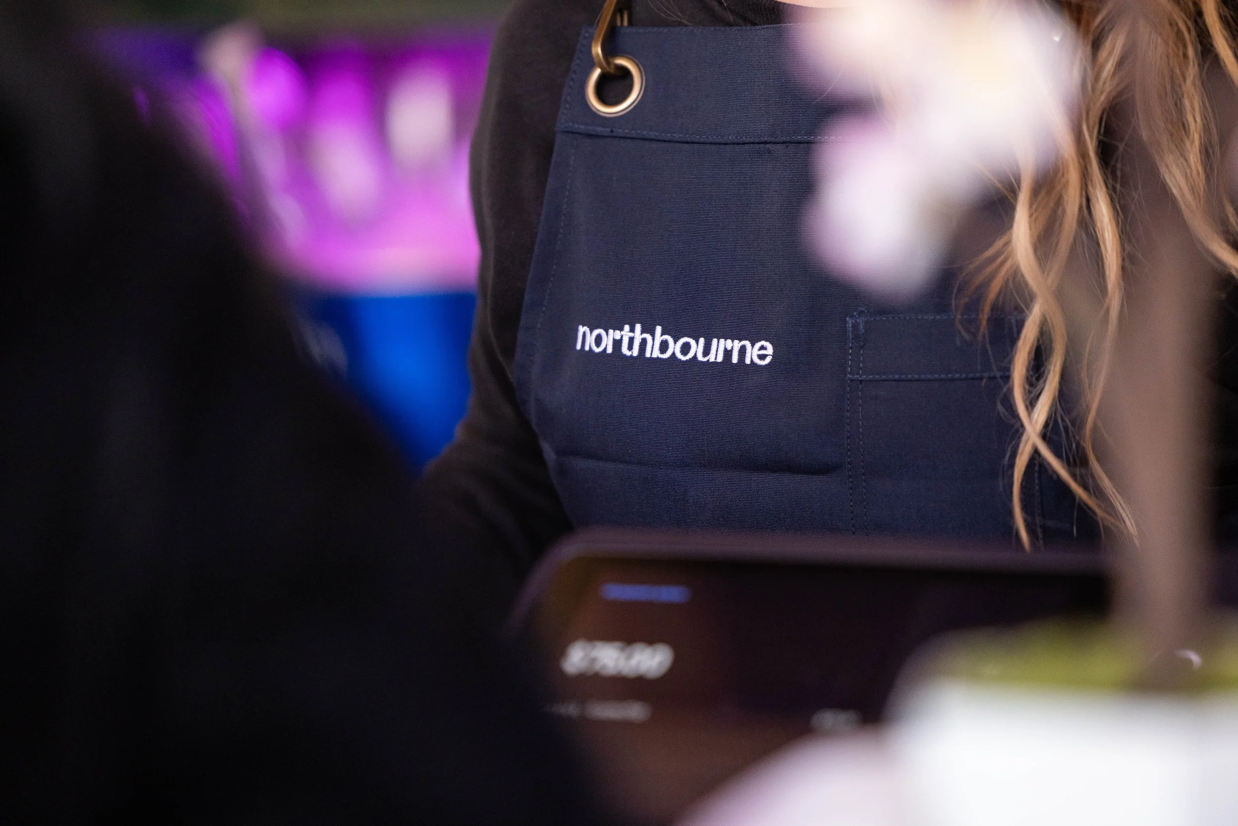 Close up of Northbourne branded apron on a staff member.