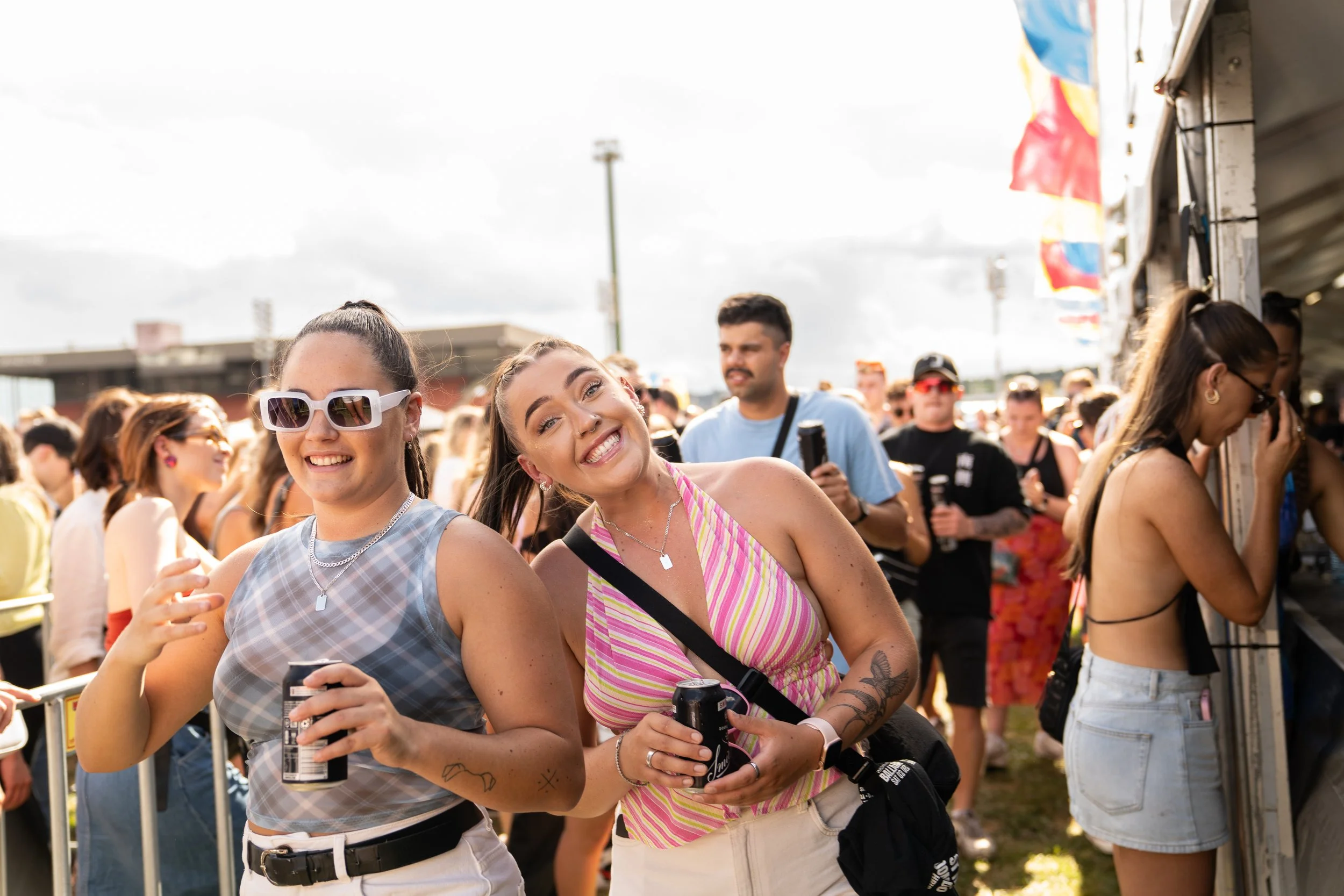two girls smiling at a festival bar