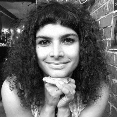 black and white image of woman aged 25 with black curly hair