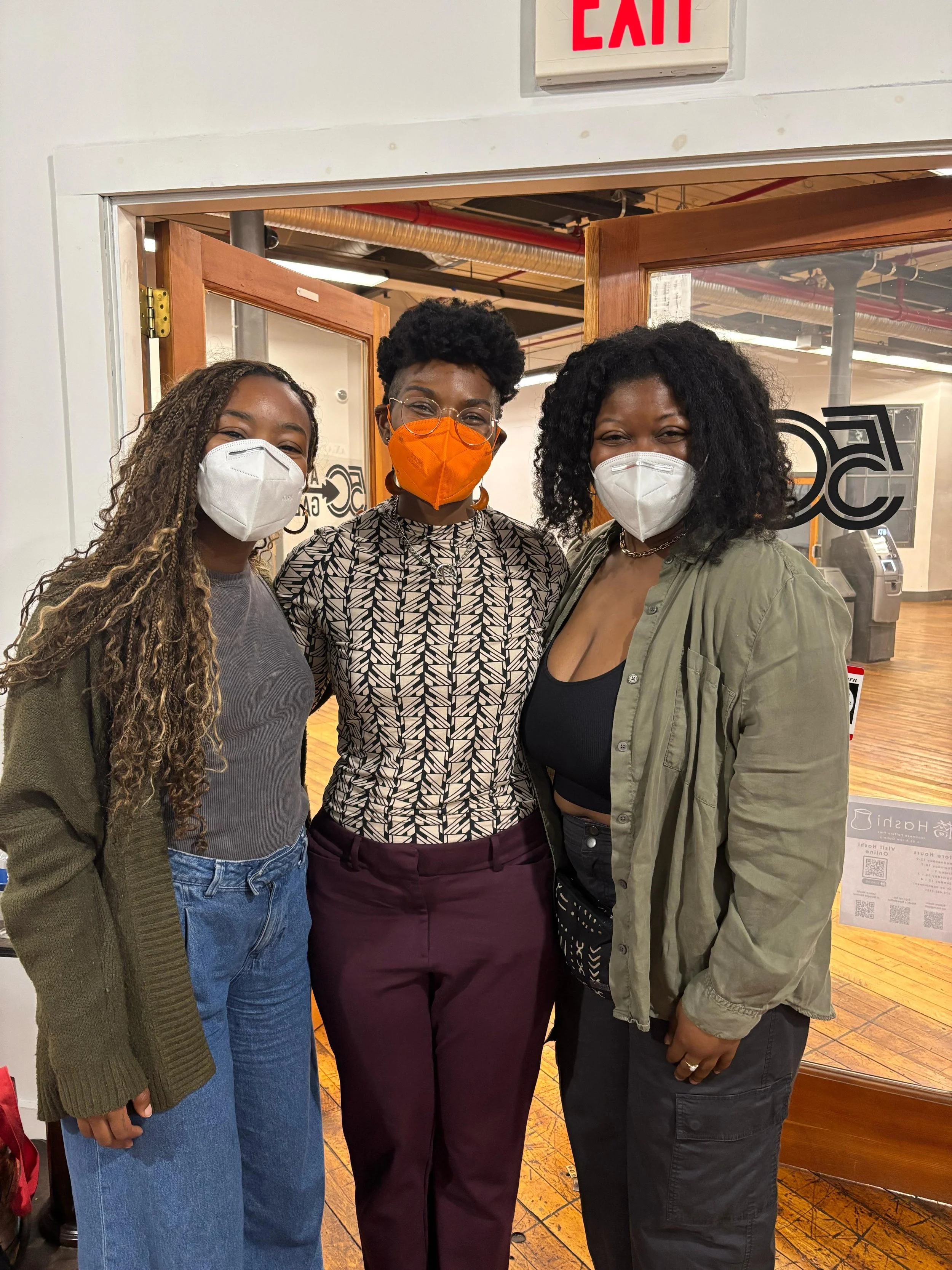 Kenyatta surrunded by two friends at the screening in Easthampton, MA