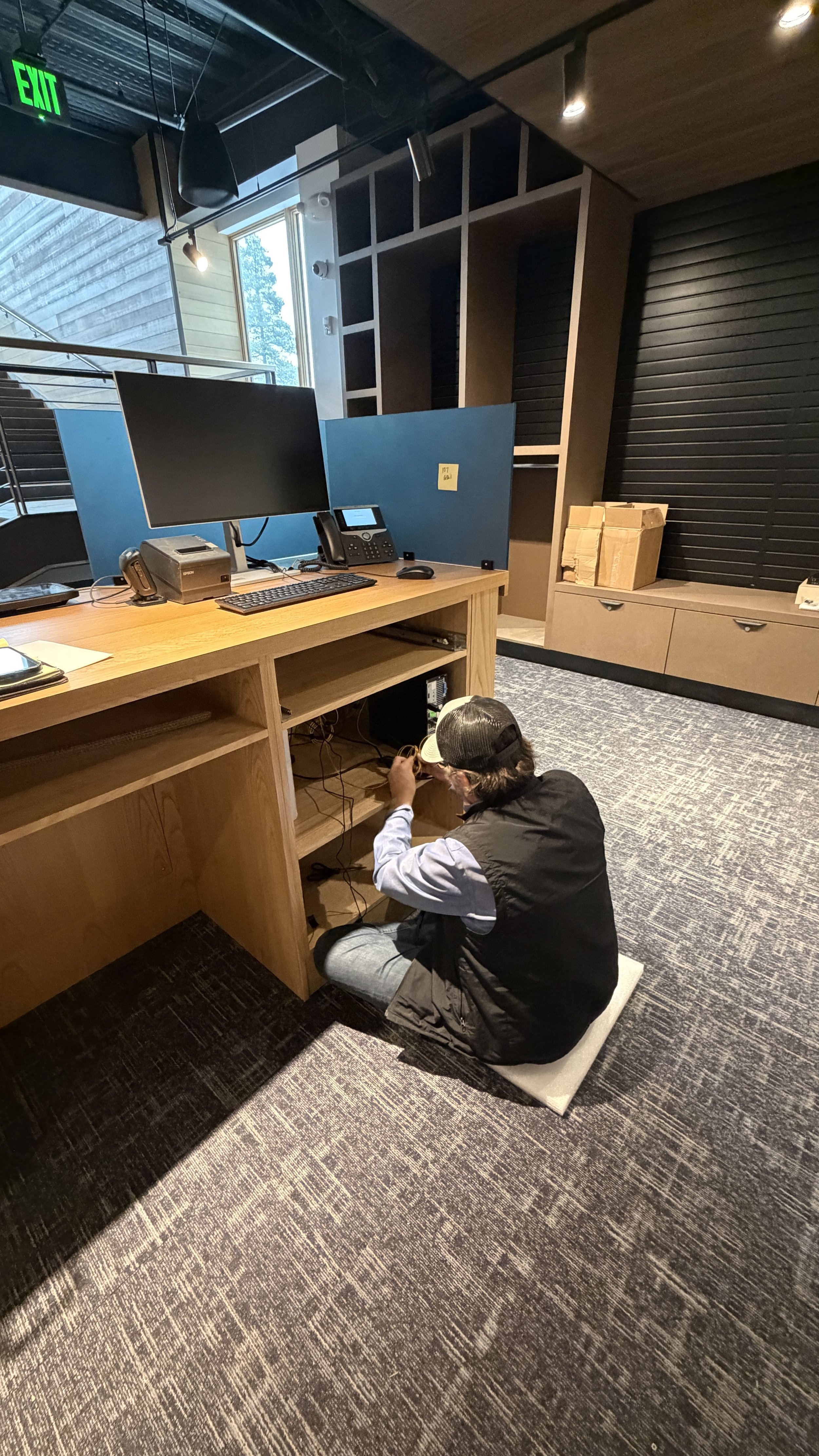 A technician works beneath a workstation counter during the Tahoe Donner ski-lodge installation.