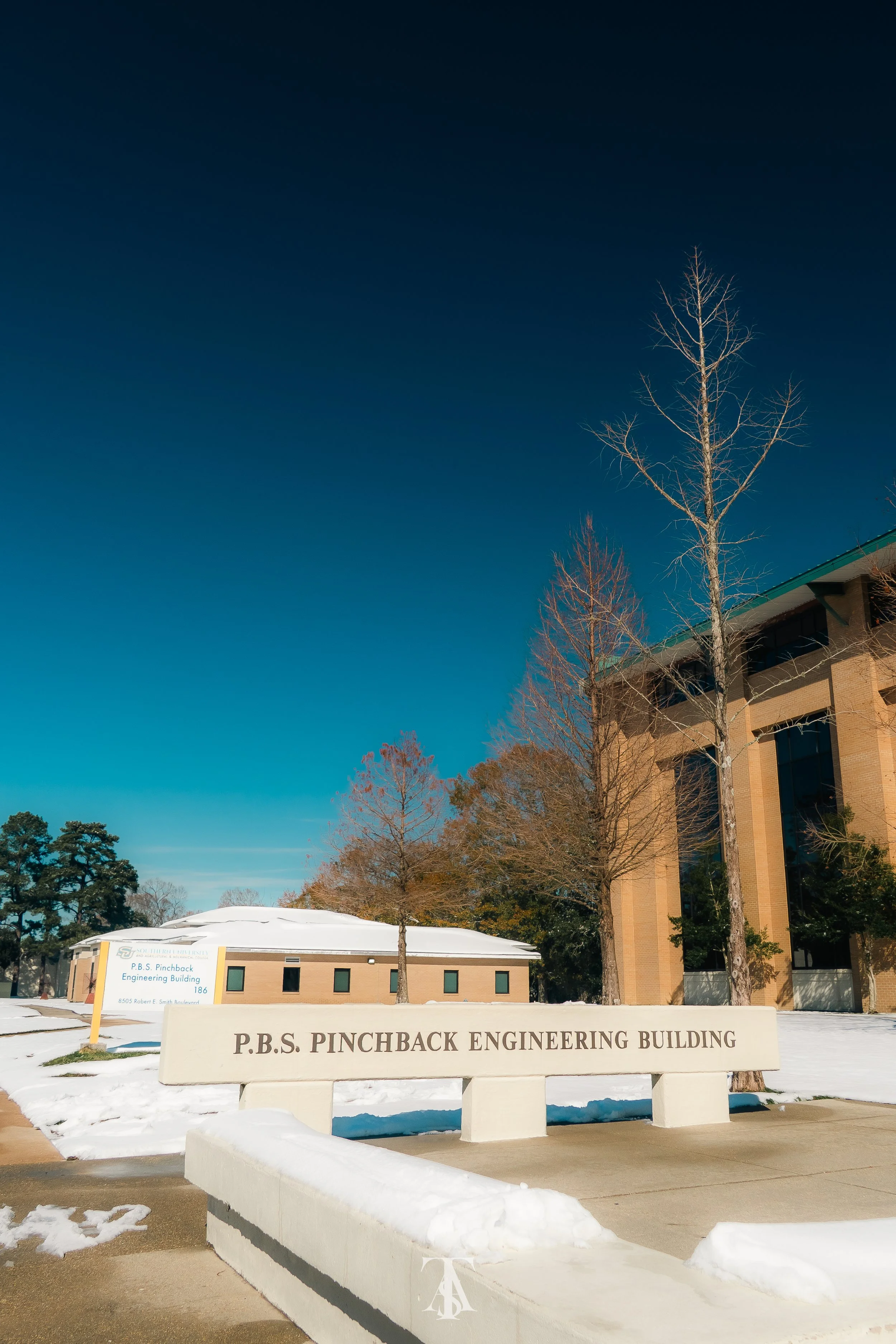Photo of the P.B.S. Pinchback Engineering Building with snow on the ground and clear blue sky.