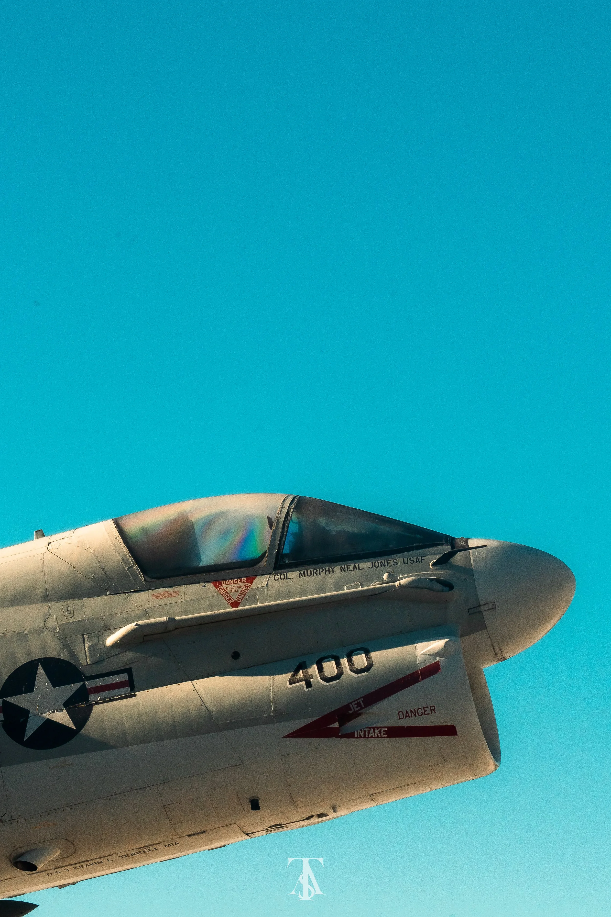 Close-up of a fighter jet aircraft with a blue sky background