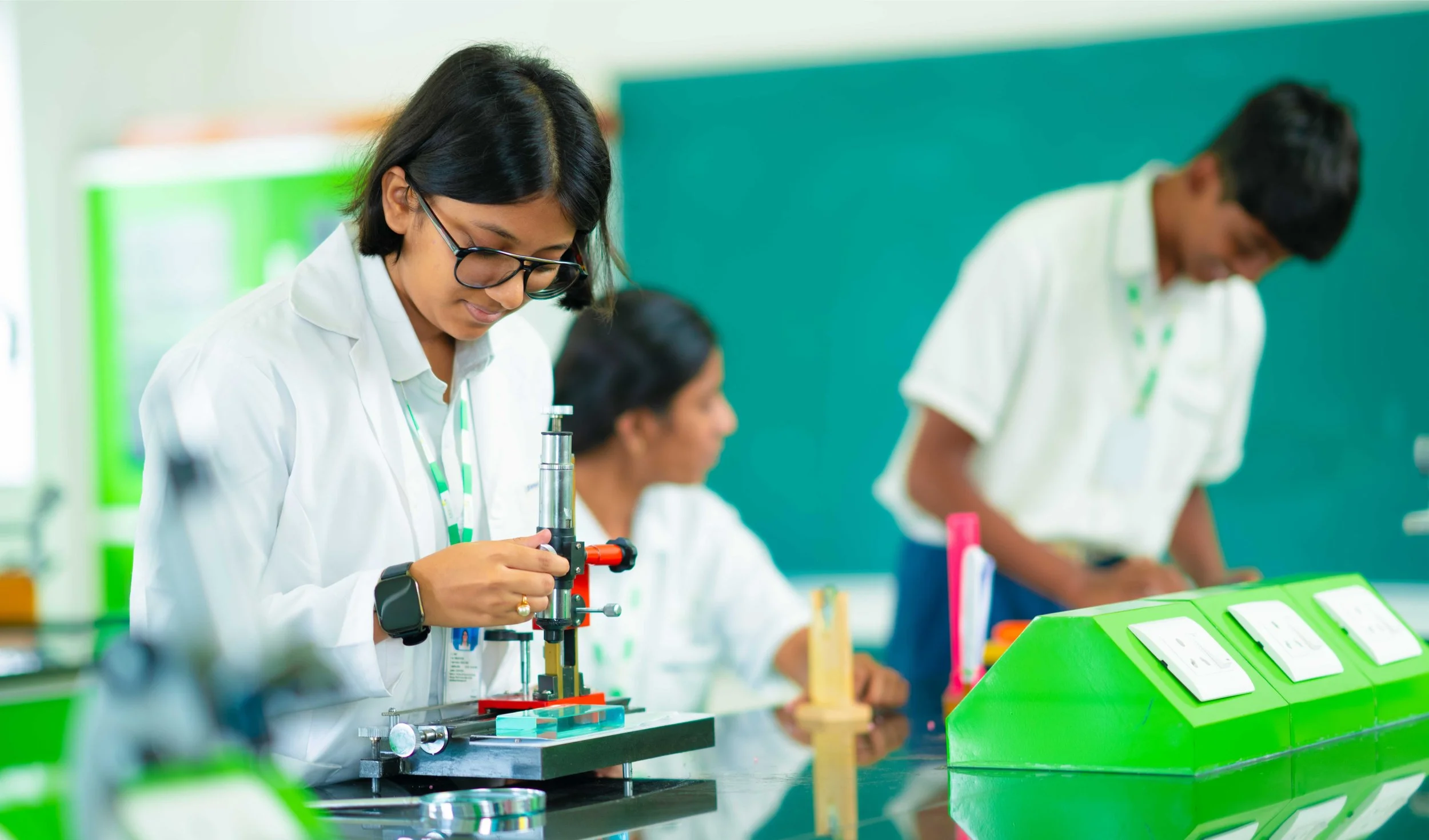 Students conducting experiments in a science lab with lab coats and equipment