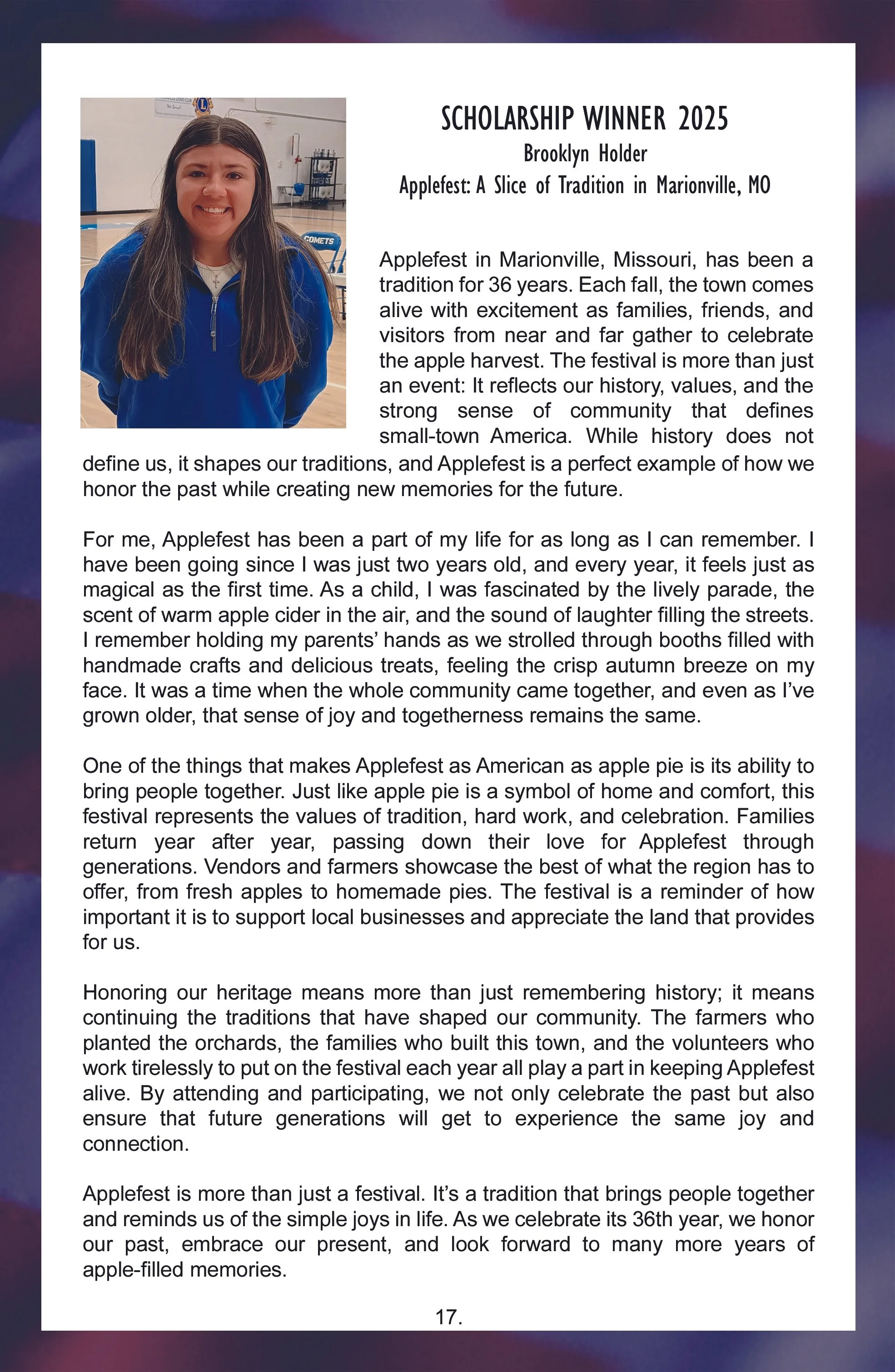 A young girl standing in a gymnasium, wearing a blue jacket and smiling.