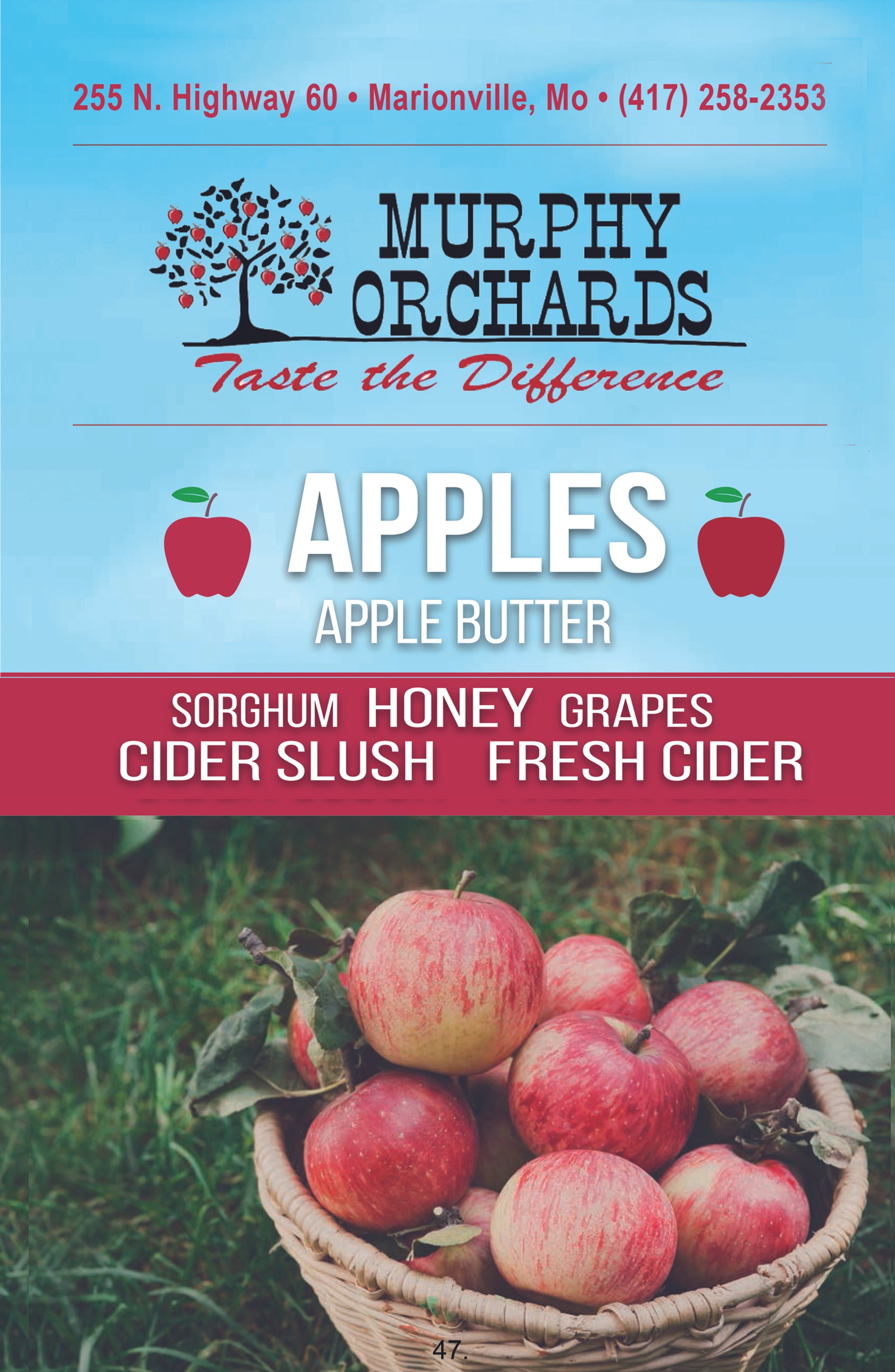 Sign for Murphy Orchards offering apples and apple products, with a basket of apples in the foreground