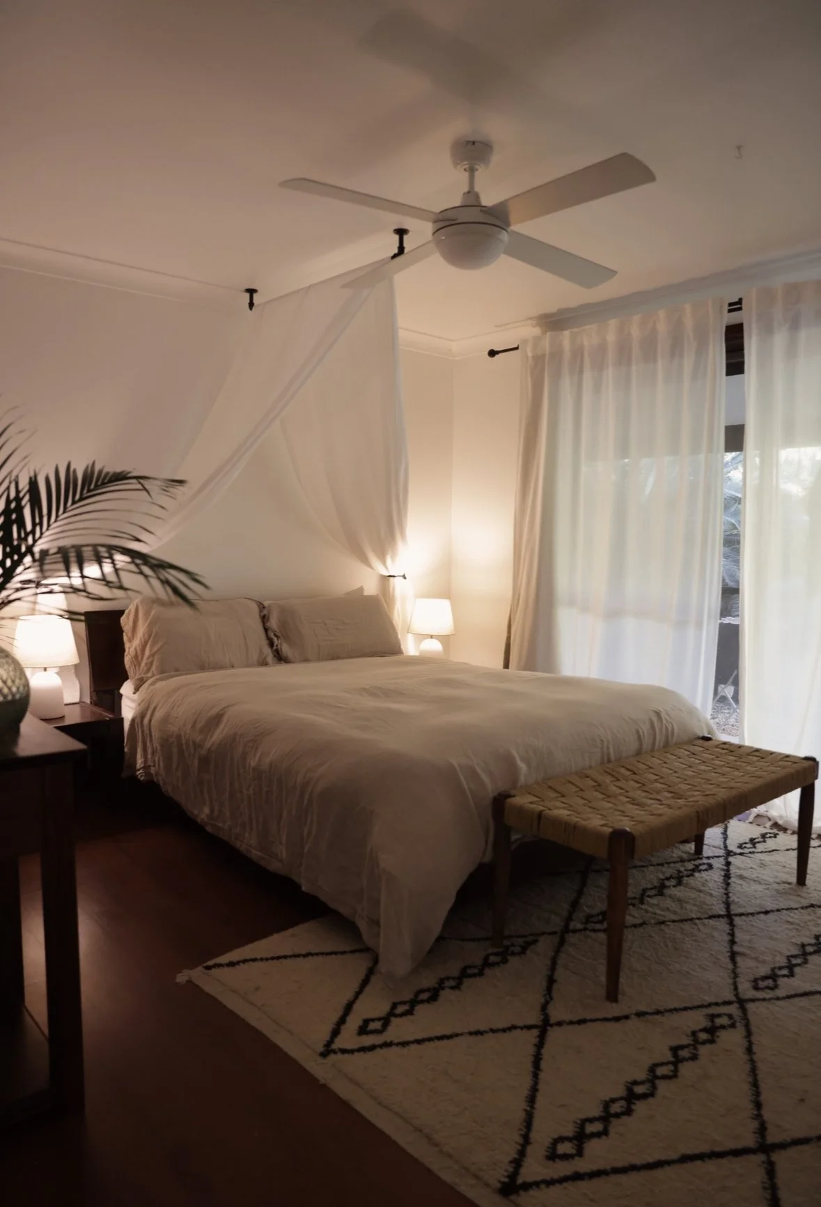 Bedroom styling detail featuring layered linen, bedside décor and natural finishes.