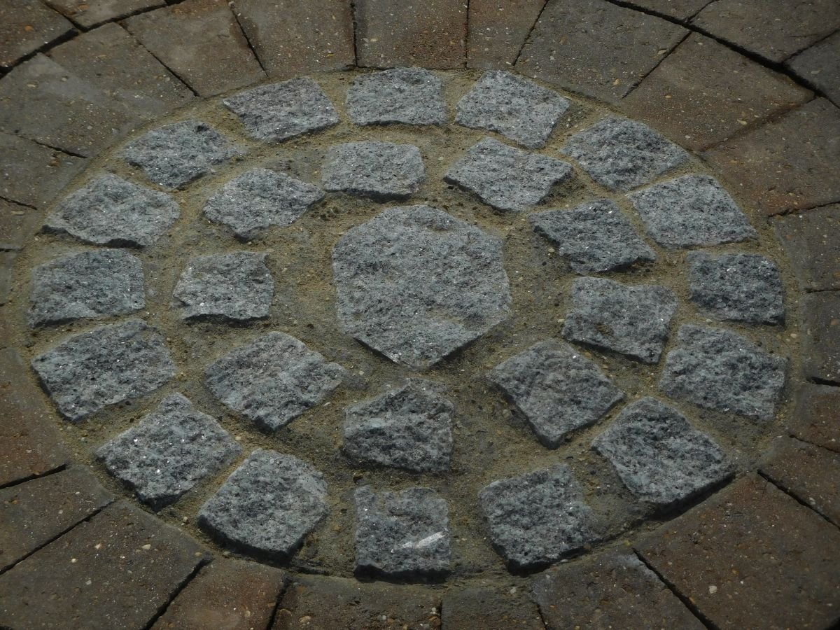 Circular stone pattern on pavement