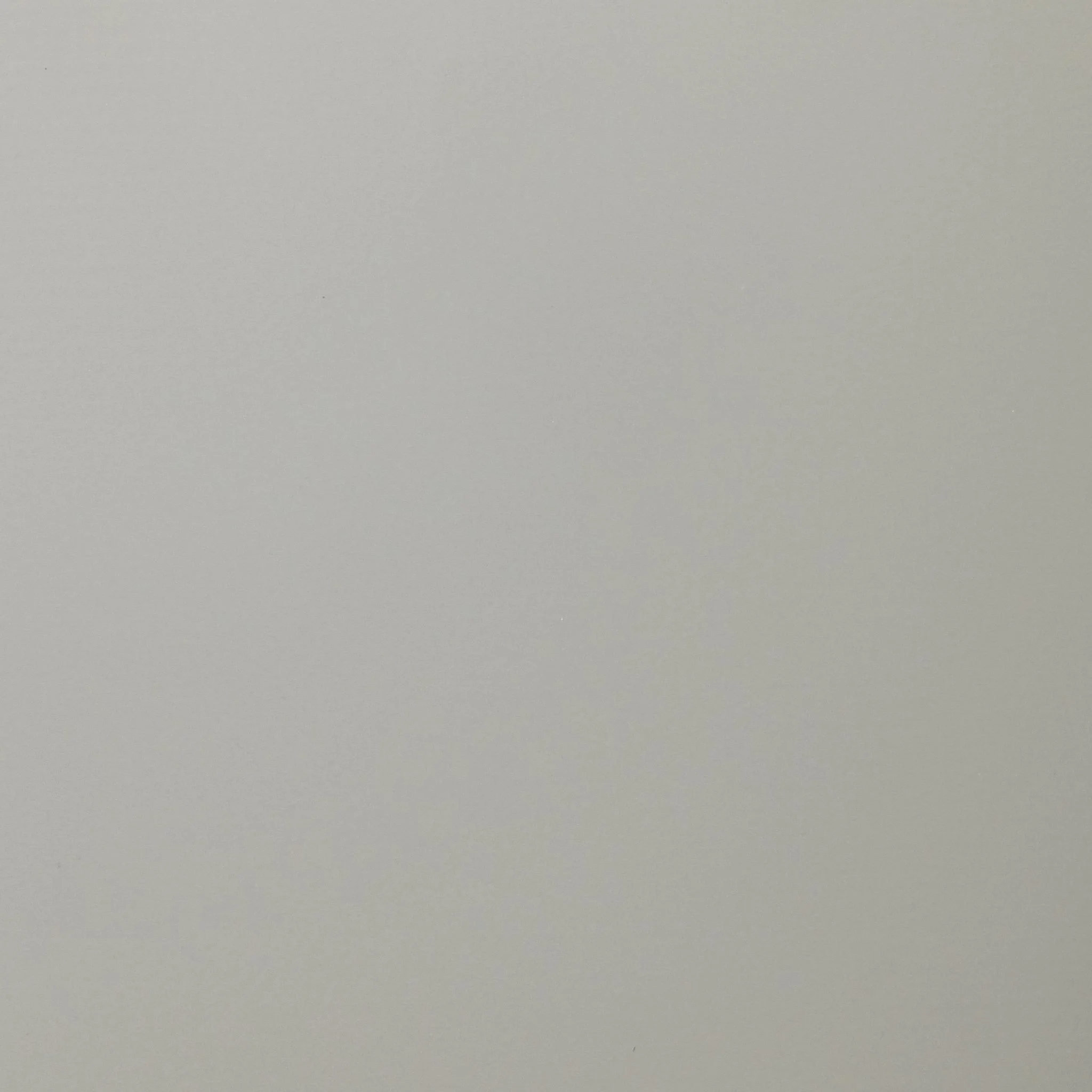 A blank, light gray surface, possibly a wall or background, with no distinct objects or details.