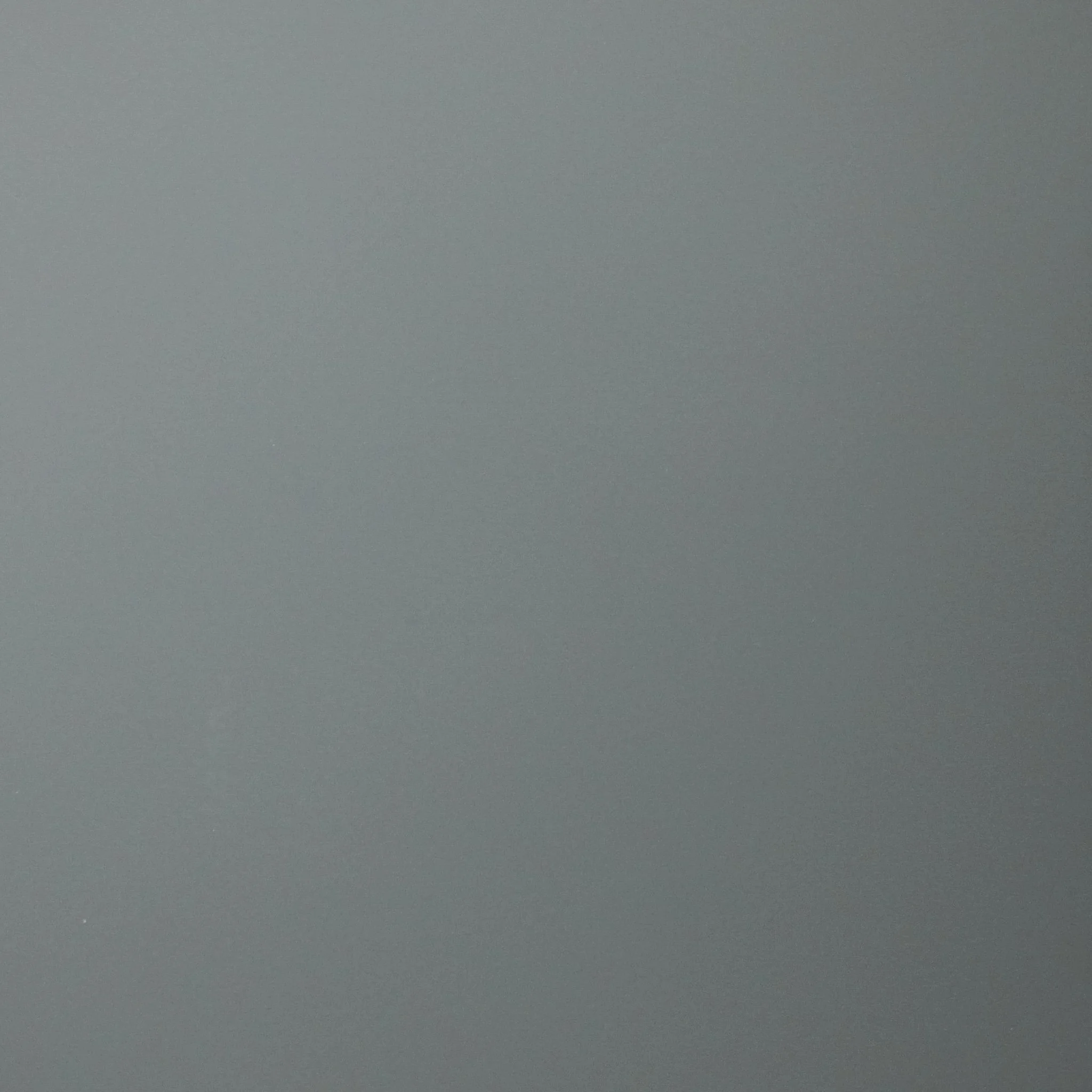 Blue-gray surface with a subtle gradient, no objects or distinct features.