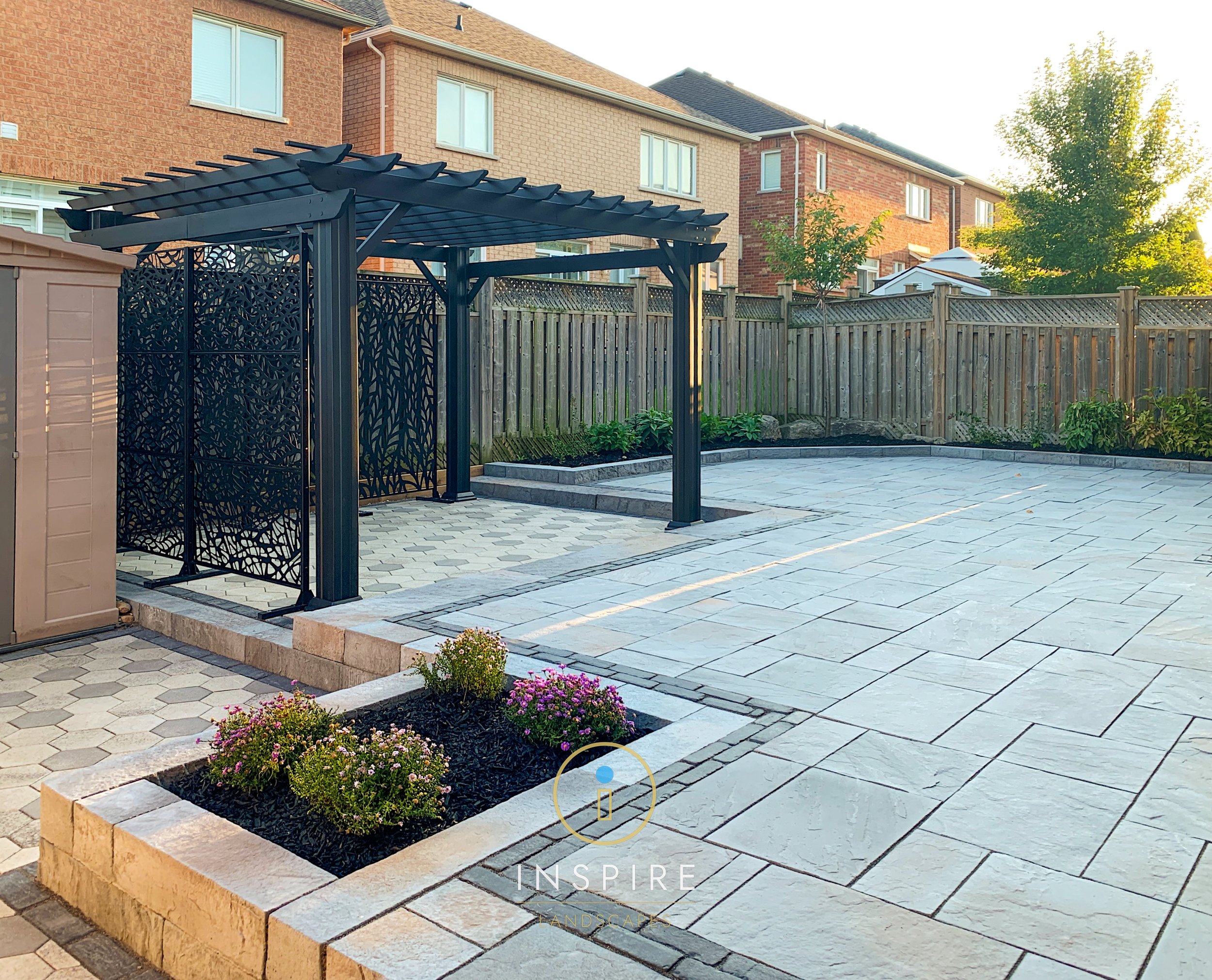 Back yard patio with custom aluminum pergola and Techo-Bloc and Unilock Pavers.