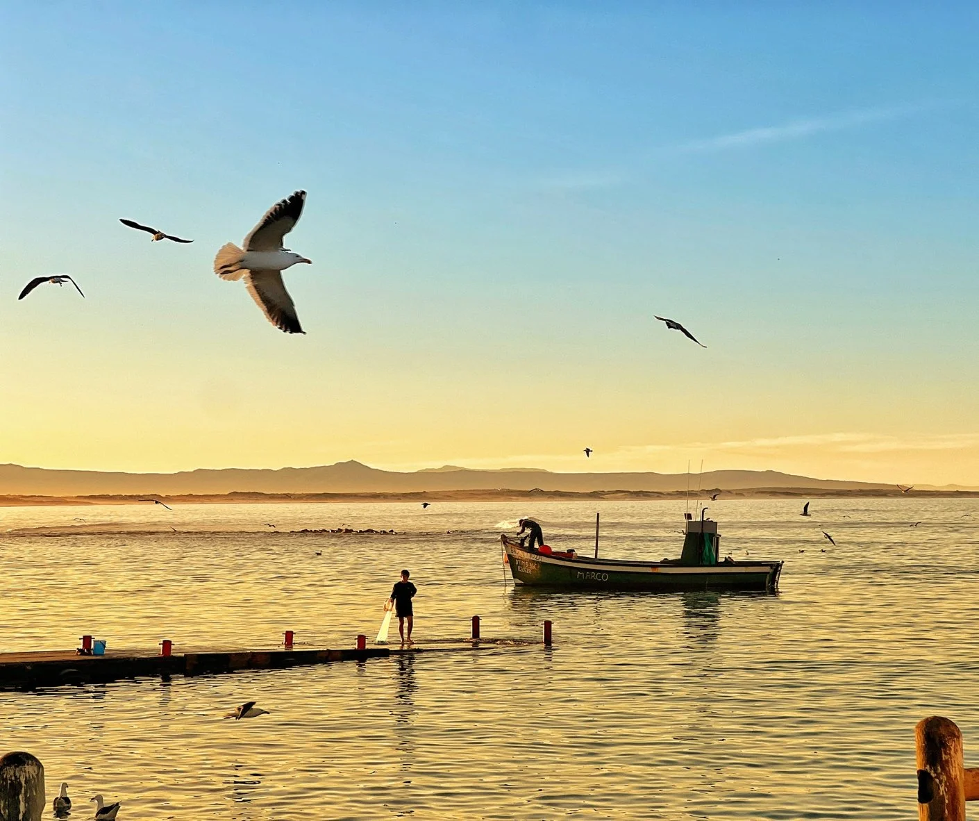 There&rsquo;s a rhythm to summer down here &mdash; early swims in clear fresh water, sandy feet at the harbour, and sunsets that seem to hold still just for Struisbaai.

Families stroll for ice creams. Fishermen launch before dawn. The air smells of 