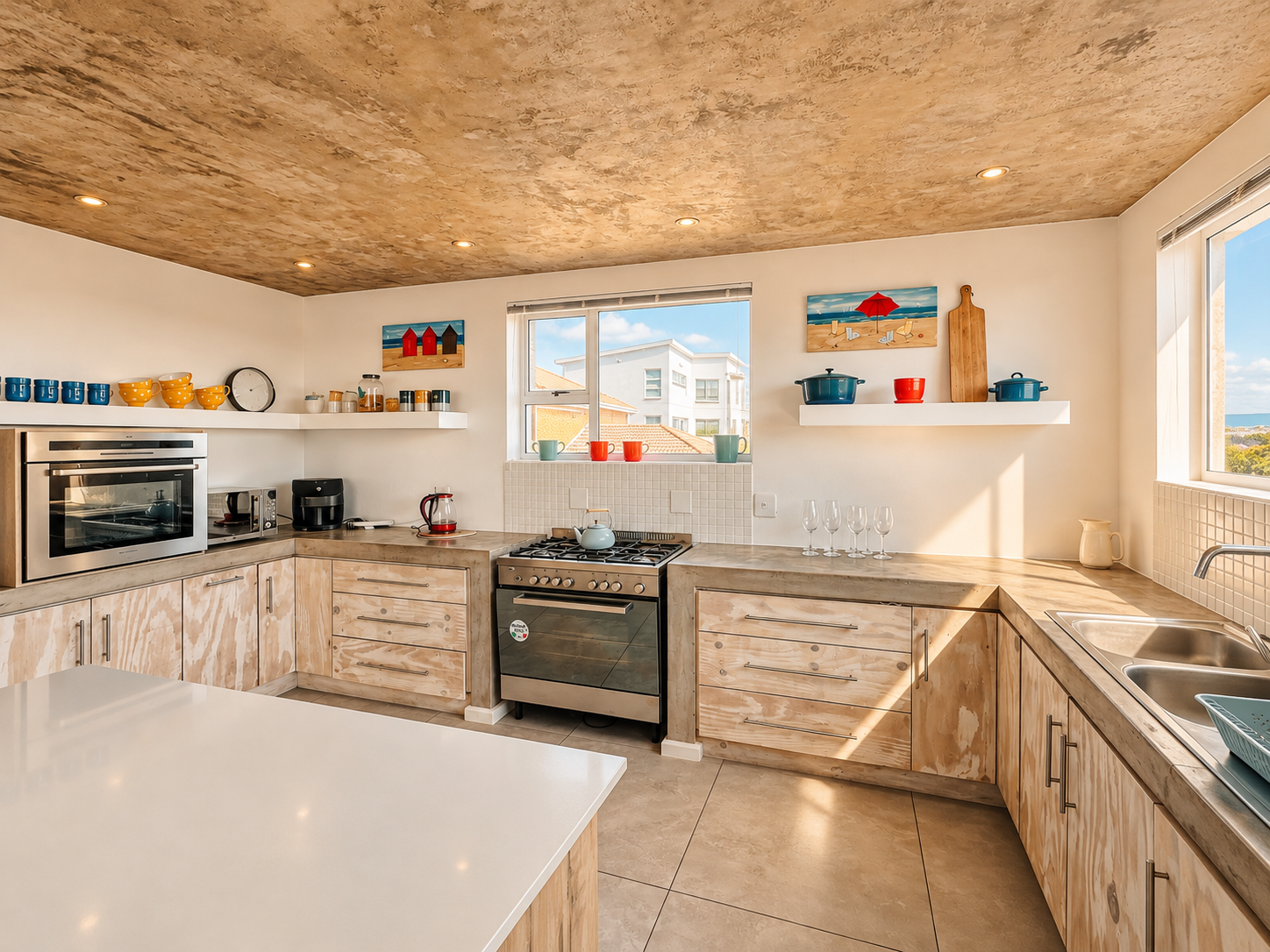 Kitchen with countertop appliances and light cabinetry