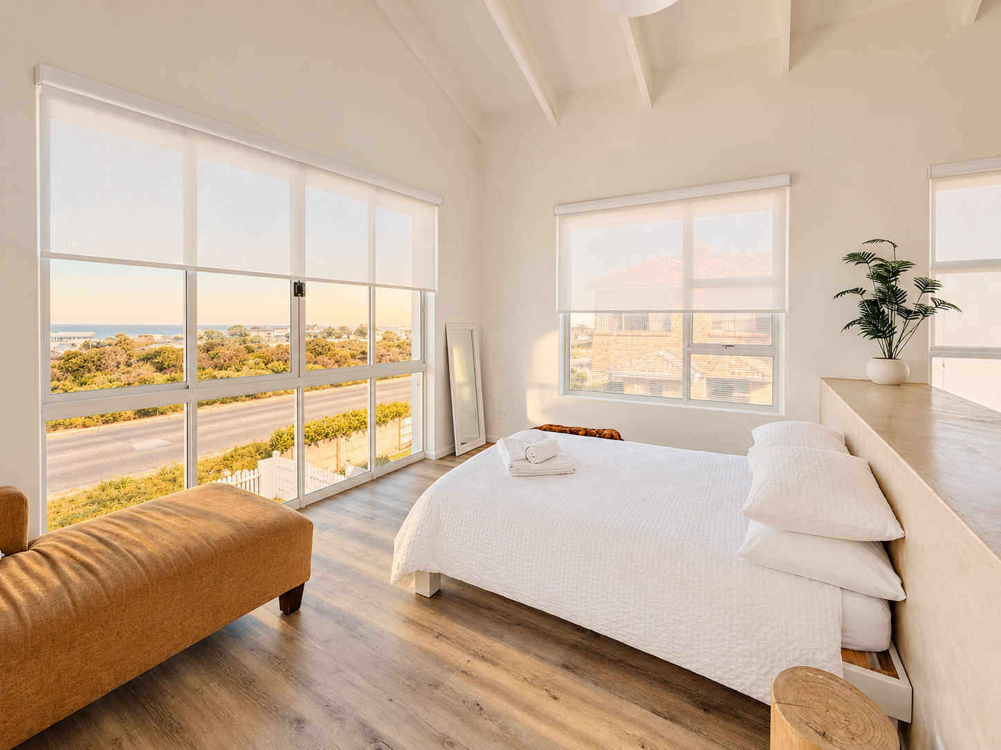 Bright bedroom with corner windows and coastal views