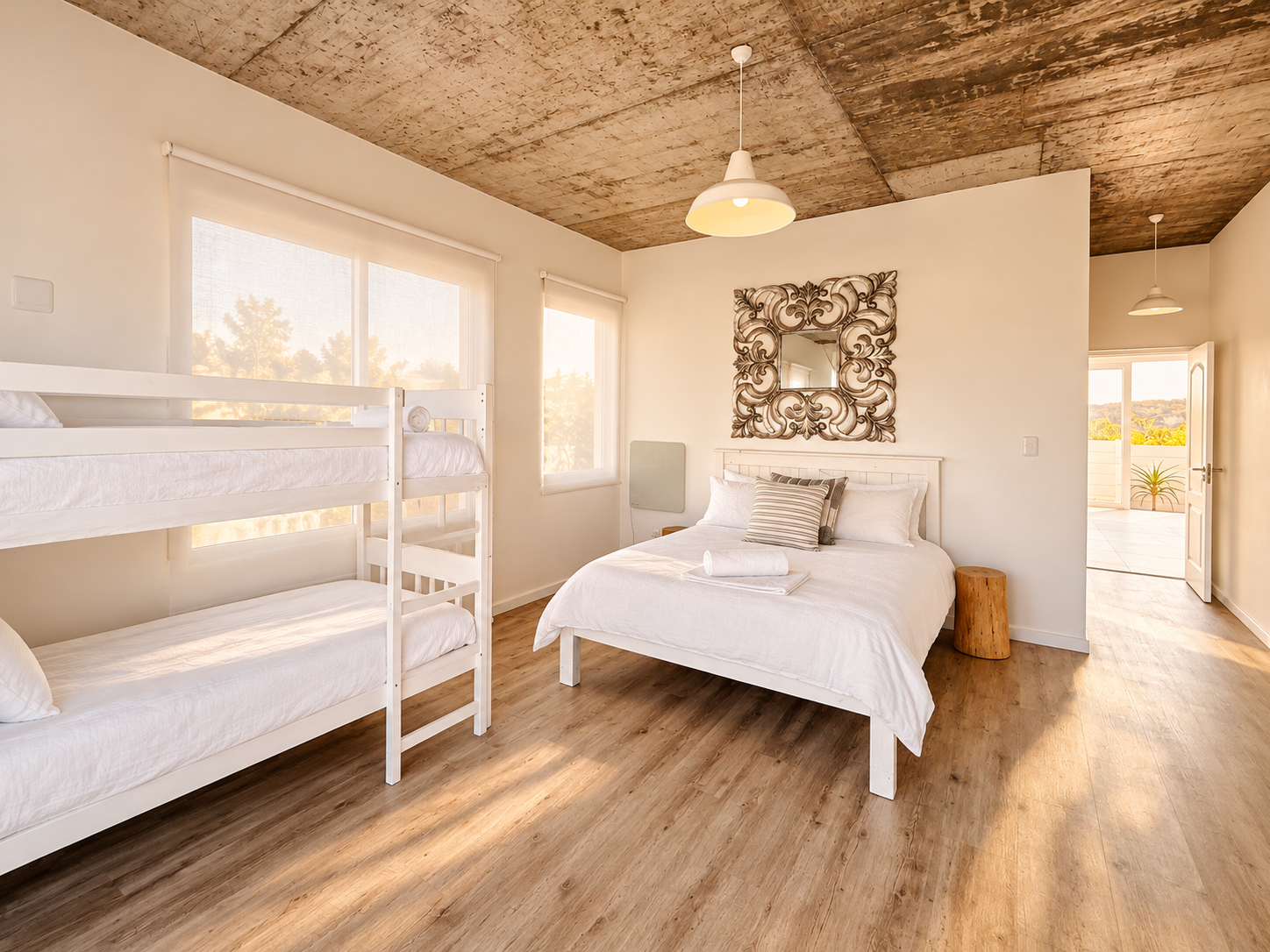 Bedroom with a double bed and white bunk beds