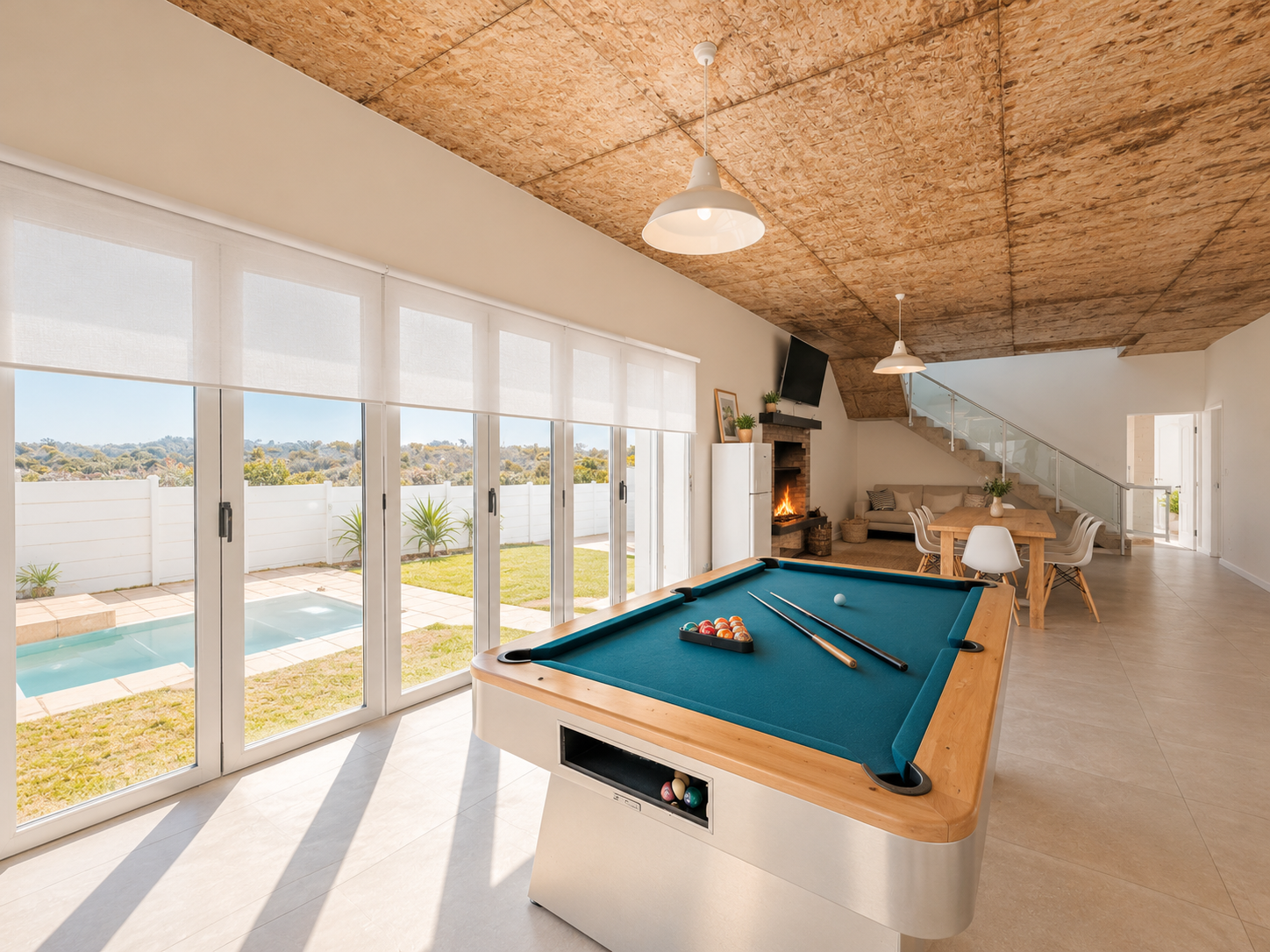 Downstairs games room with pool table and garden-facing glass doors