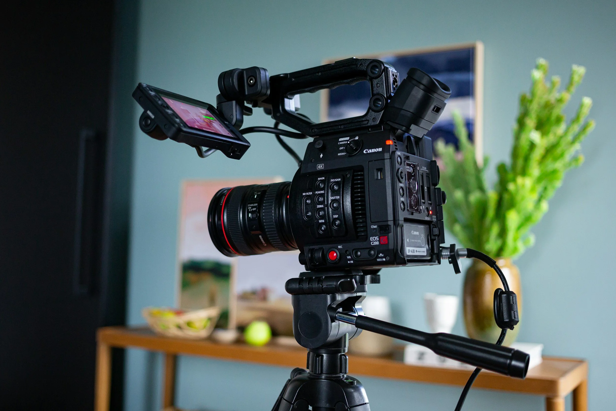 Professional camera filming a podcast interview with microphones and studio setup