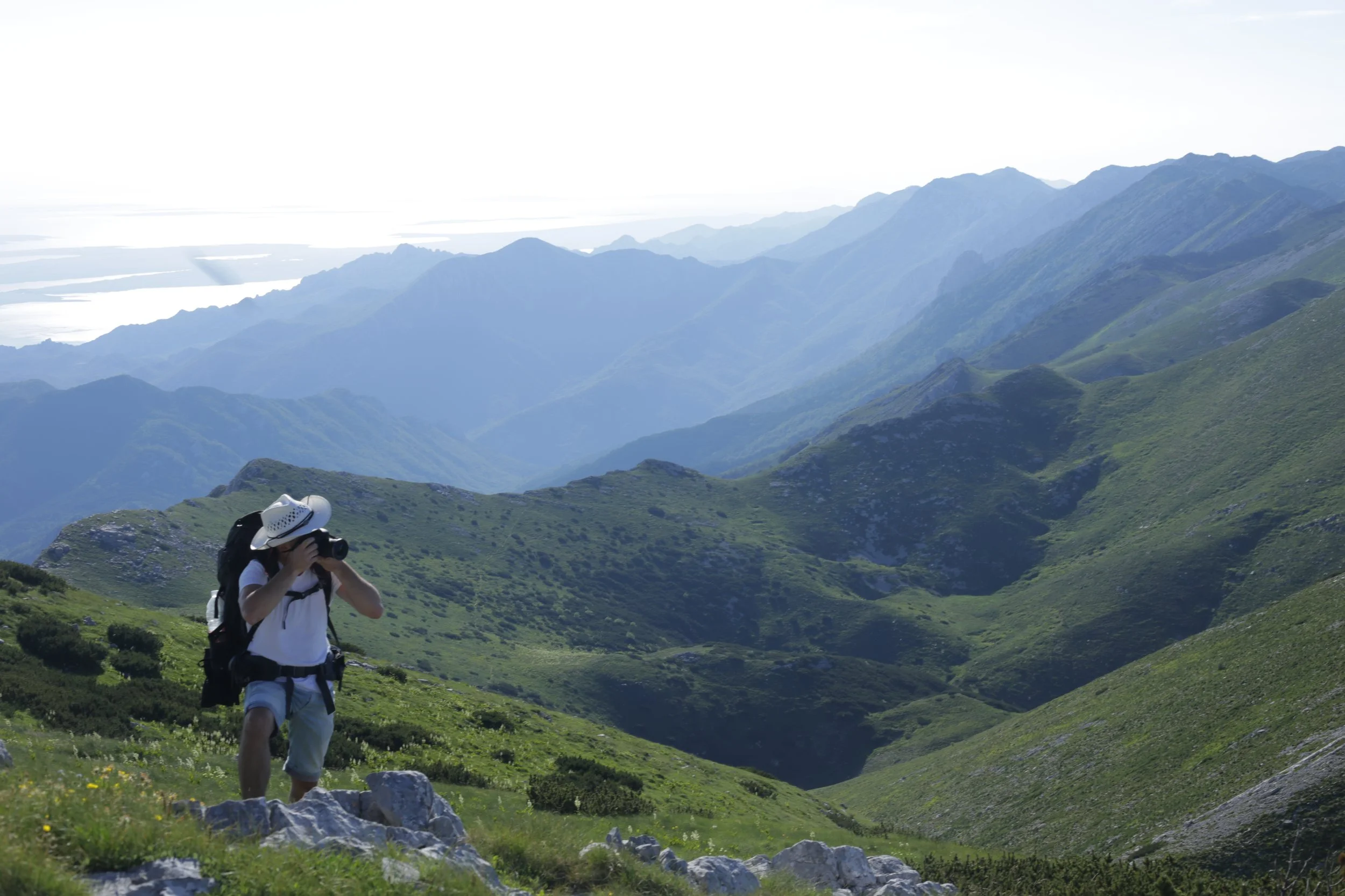 Edo Šturlić, local fixer in Croatia, photographing a scenic mountain location while providing on-the-ground production support