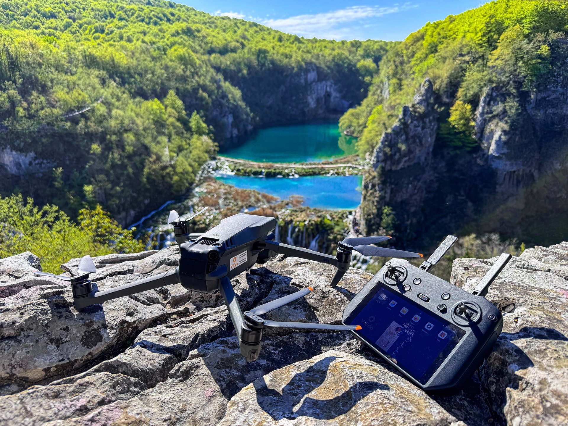 Drone flying over Plitvice Lakes with waterfalls and river, illustrating ViEdo’s drone and aerial video services in Croatia
