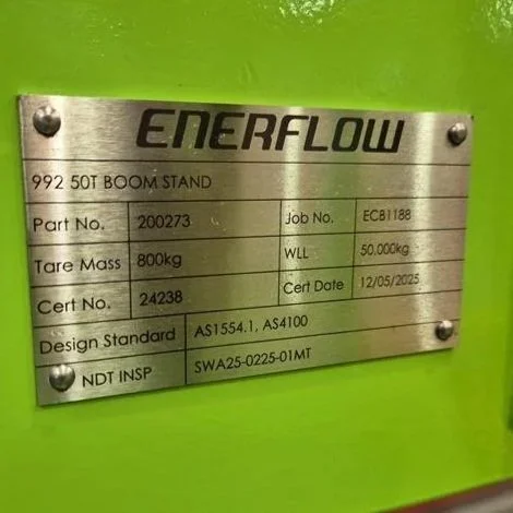 Metal identification plate for an Enerflow 992 50T boom stand, attached to a green surface.