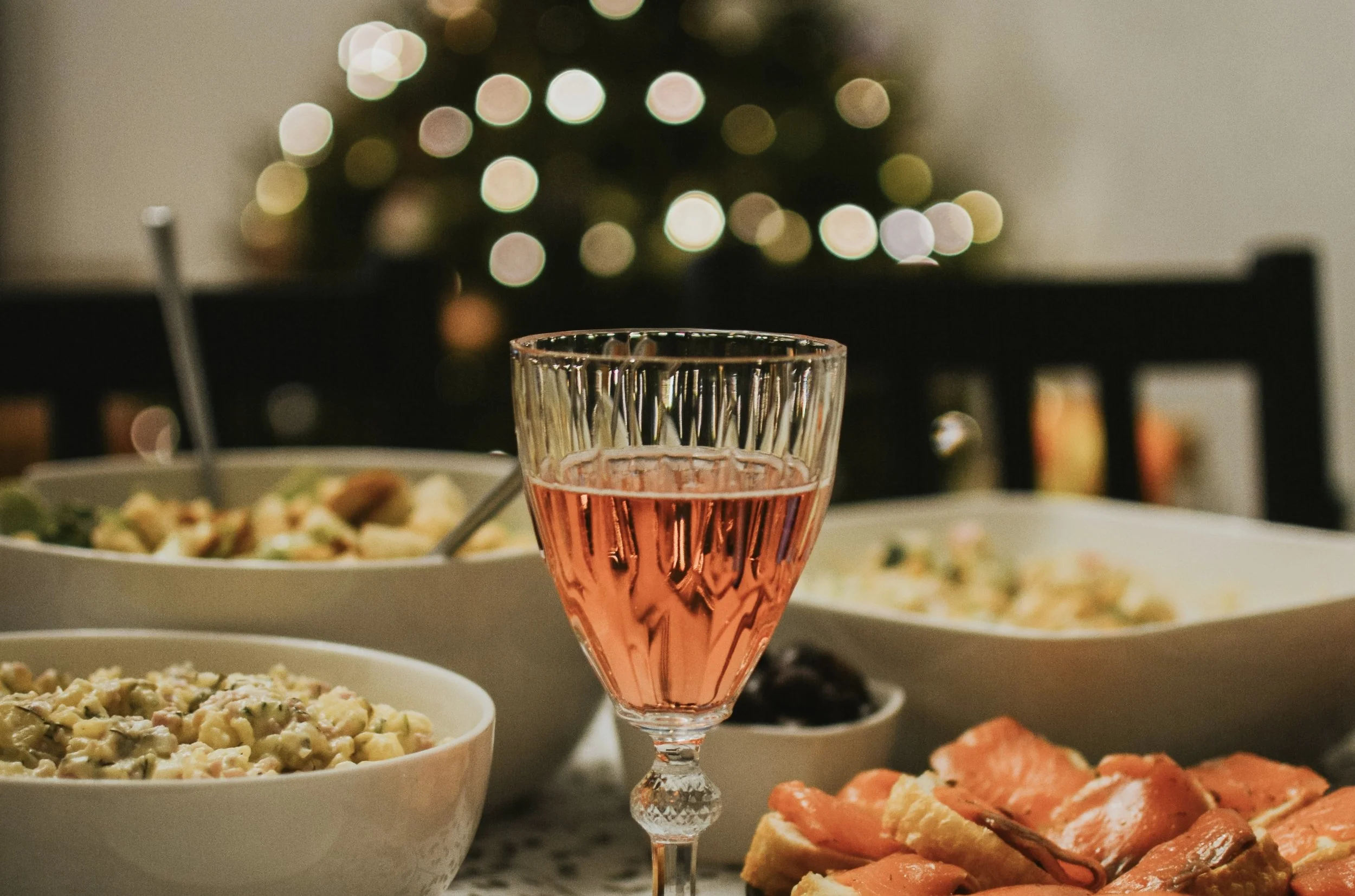 festive-christmas-table-with-pink-wine-appetizers-salads.jpg