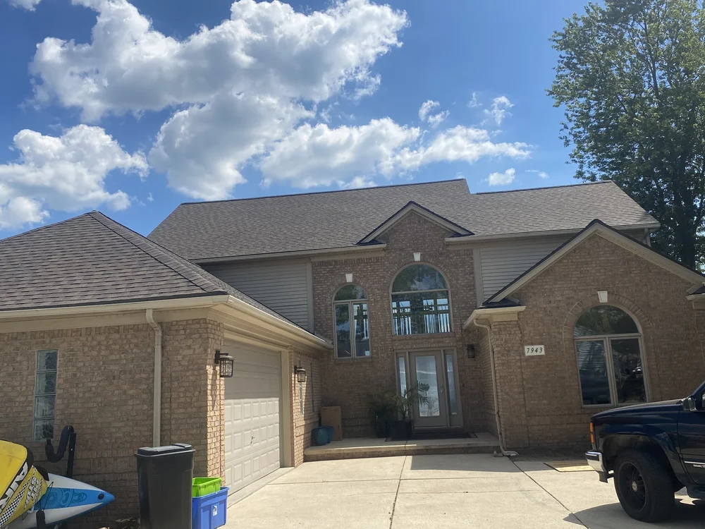 NEXT Exteriors roofing crew installing new shingles on a Royal Oak Michigan home
