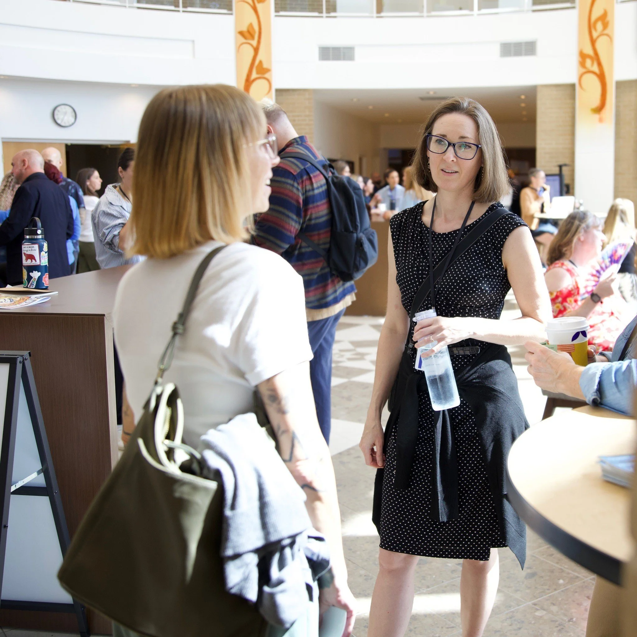 ATNS Conference Dallas 2026 Rachel and Attendee Talking in Atrium.jpg