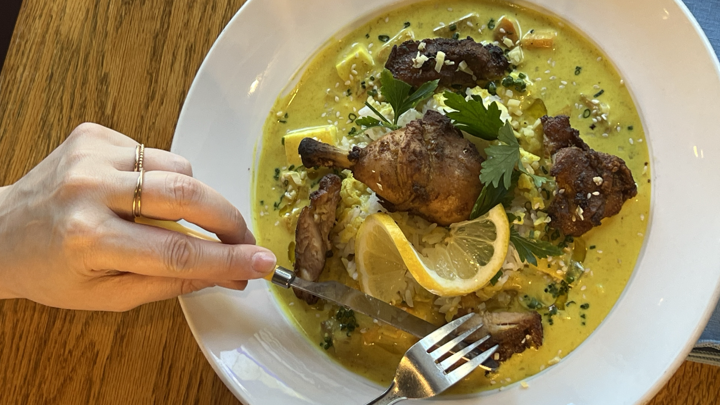 roasted vegetable curry with indian spiced chicken (fork and knife in hands)