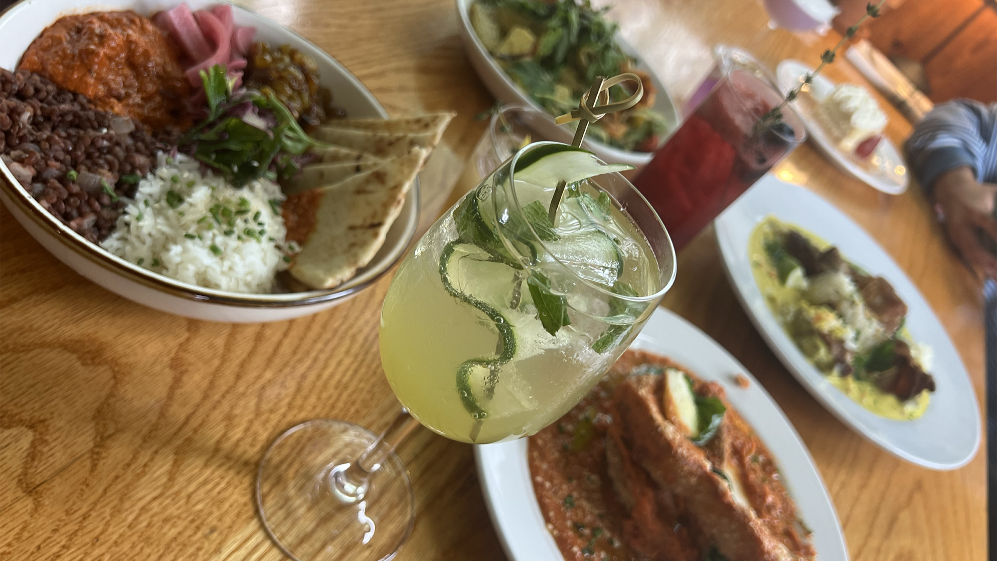 wooden table with various dishes and cocktails