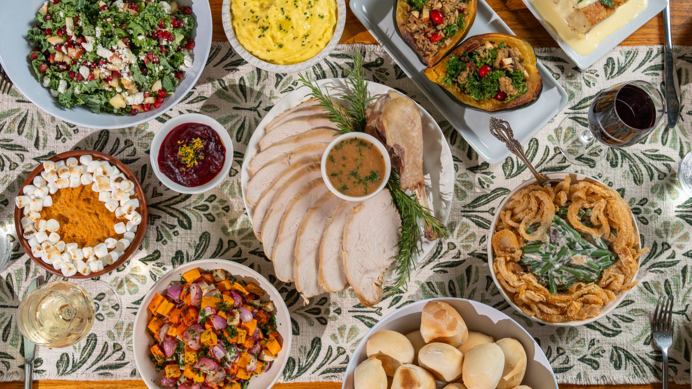 Thanksgiving tablescape with all the fixin's. Turkey and gravy, stuffed squash, wellington, roasted root vegetables, green bean casserole, harvest salad, mac and cheese, pumpkin pie, bread pudding, yeast rolls, cranberry jam.