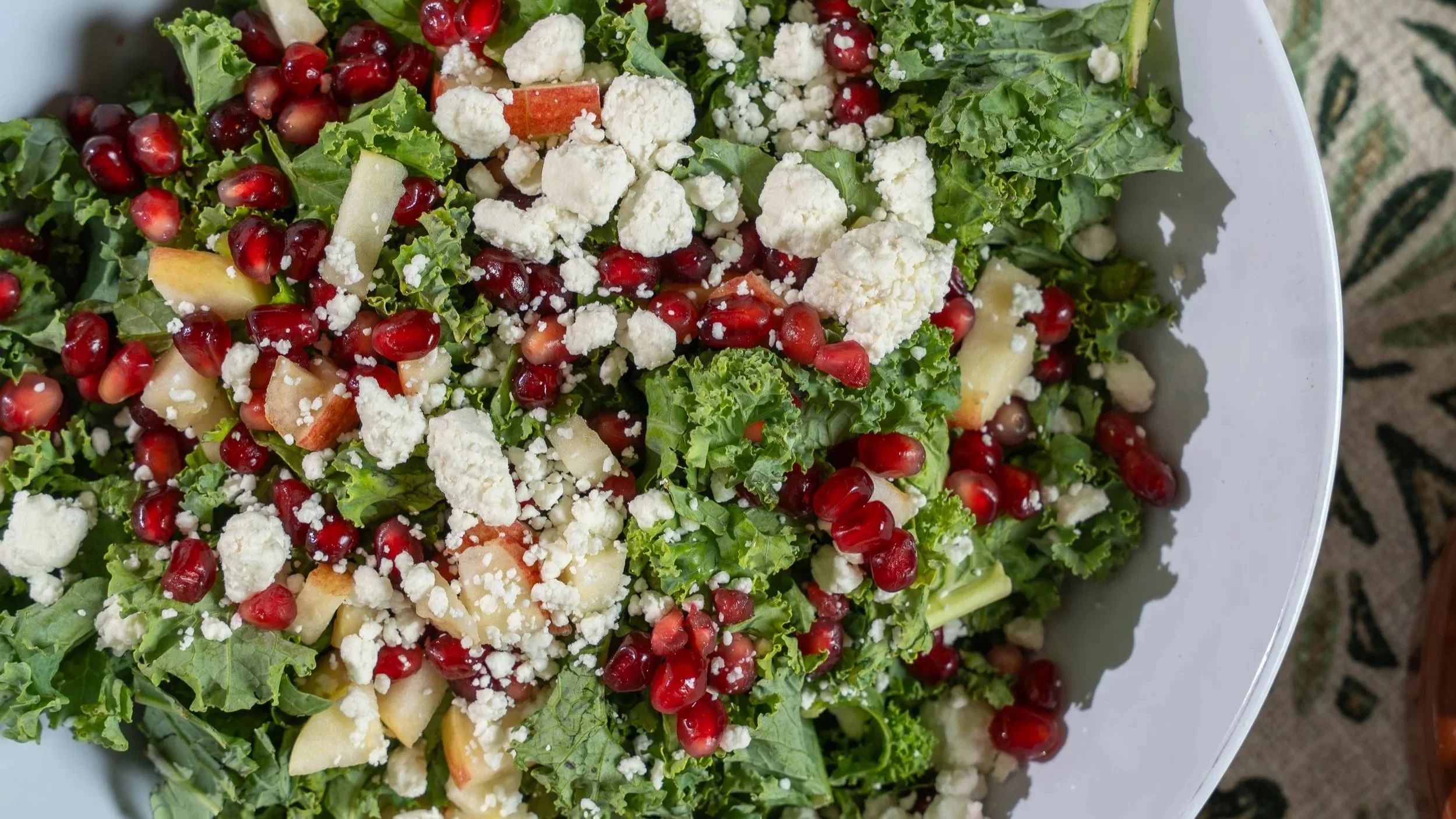 Harvest salad with goat cheese, pomegranate seeds, cranberries, apples.