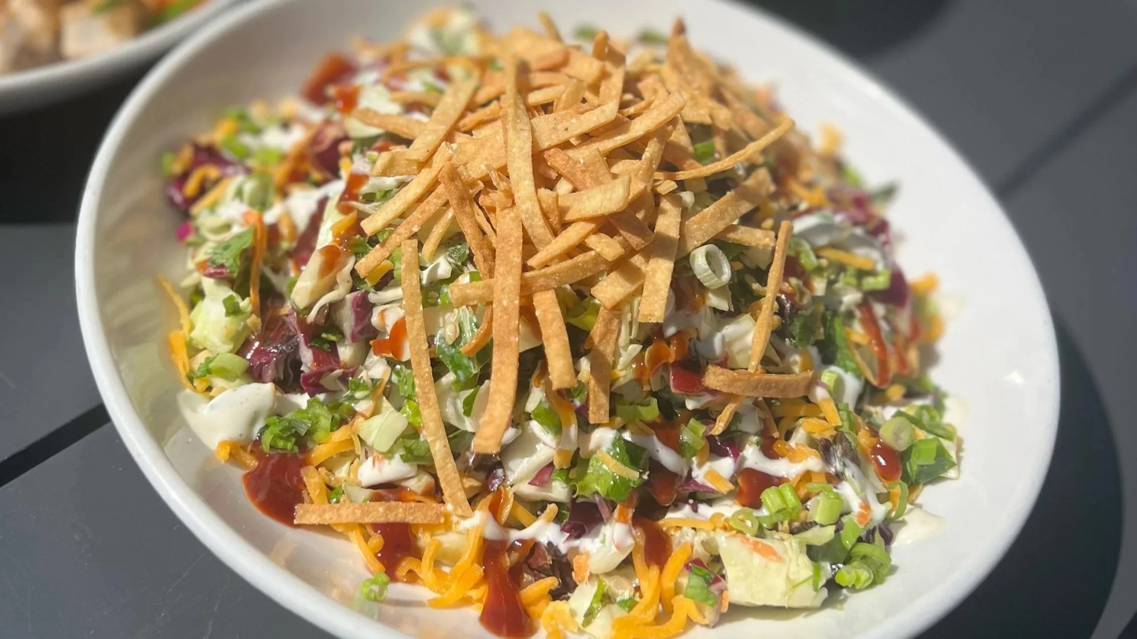 bbq chopped: cabbage, carrot, spring mix, cheddar cheese, bbq sauce, corn tortilla crisp, green onion, ranch (gluten free, vegetarian)