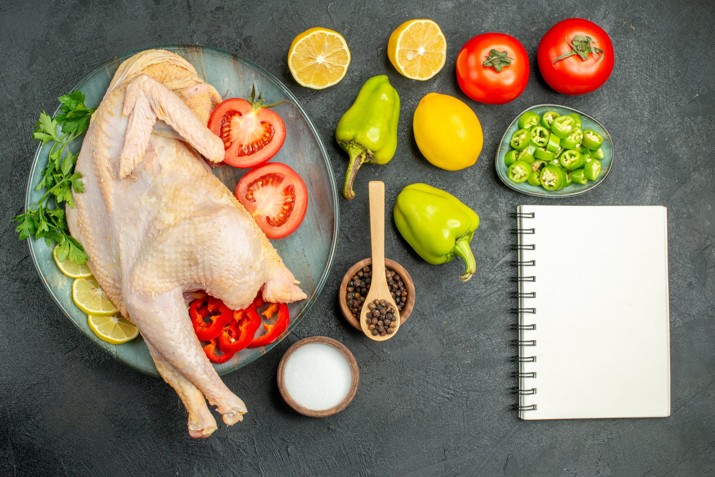 top-view-fresh-raw-chicken-with-greens-lemon-vegetables-dark-background.jpg