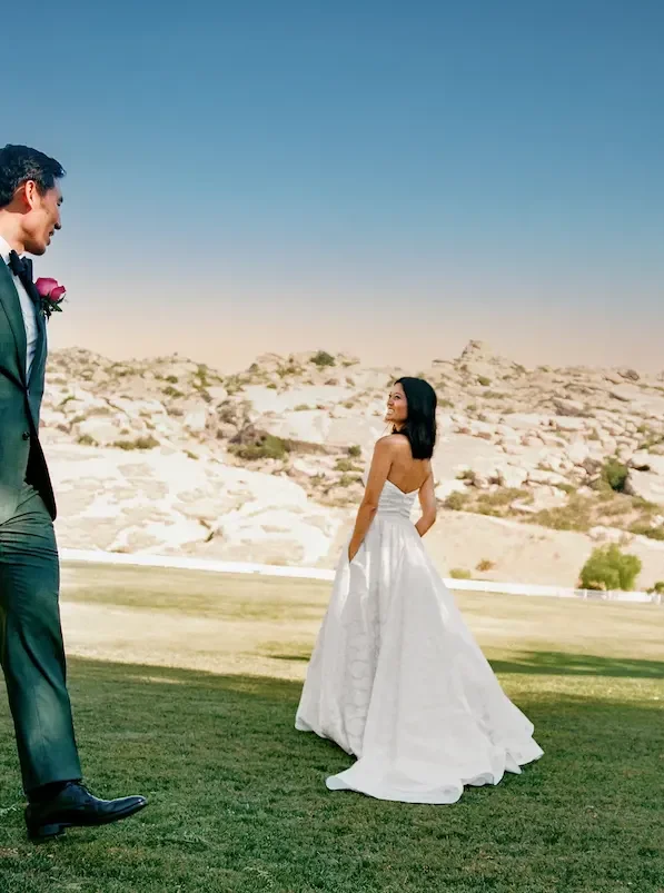 Bride and groom first look moment at Hummingbird Nest Ranch wedding in Simi Valley with mountain desert landscape shot on 35mm film