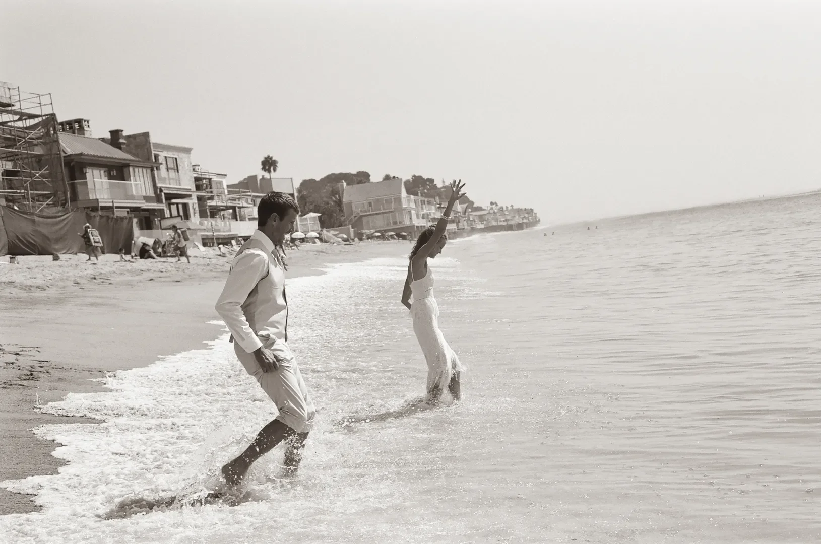 Malibu beach elopement photo on 35mm film of a couple playing in the surf along the California coastline.