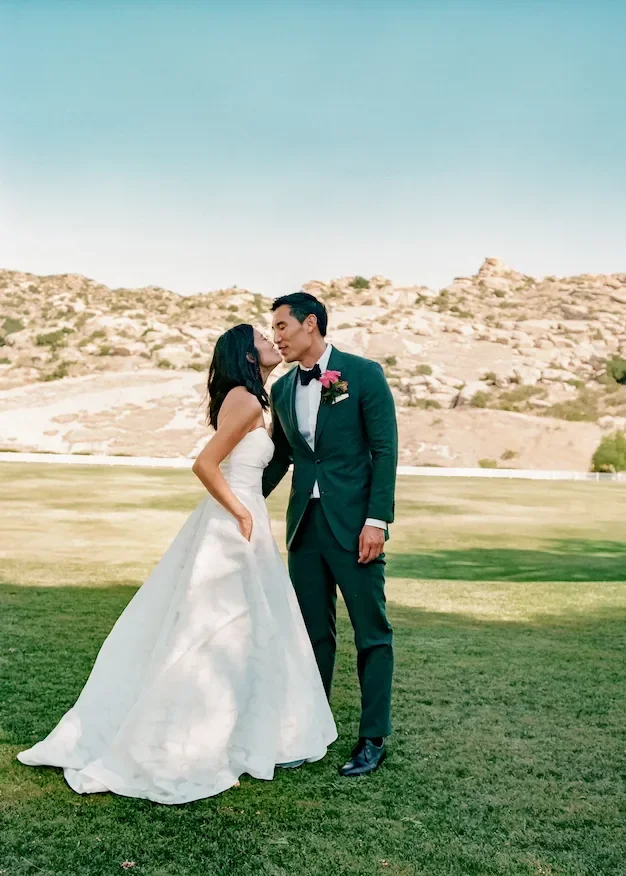 Analog film wedding portrait of bride and groom kissing at Hummingbird Nest Ranch in Santa Susana, California.