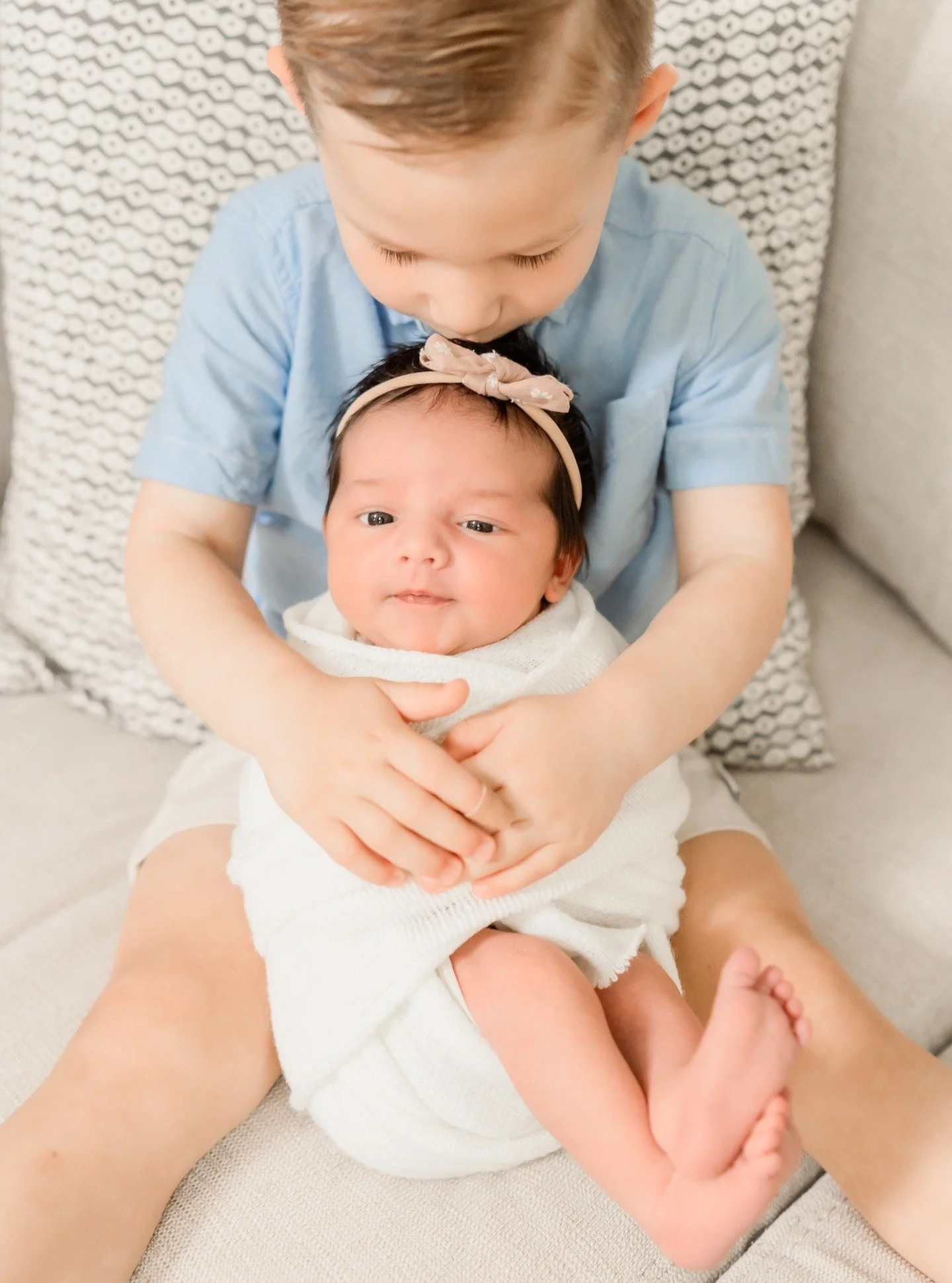 Big brother duty: giving all the snuggles, kisses, and love to his brand-new baby sister.