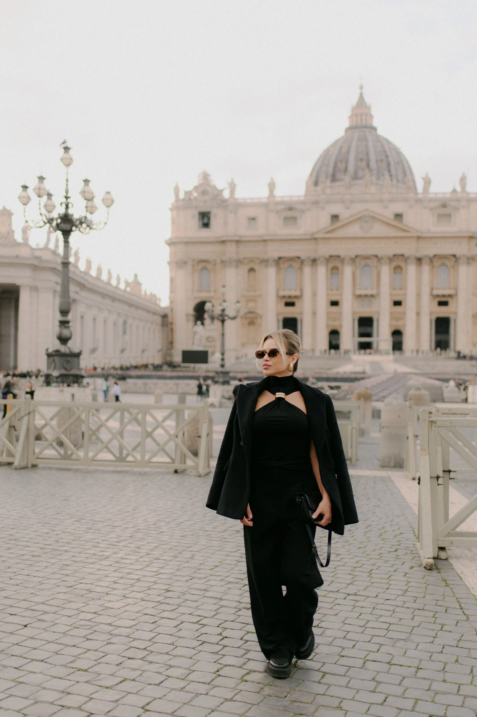 Cinematic portrait of a woman in Rome with the Vatican in the background elegant and timeless mood