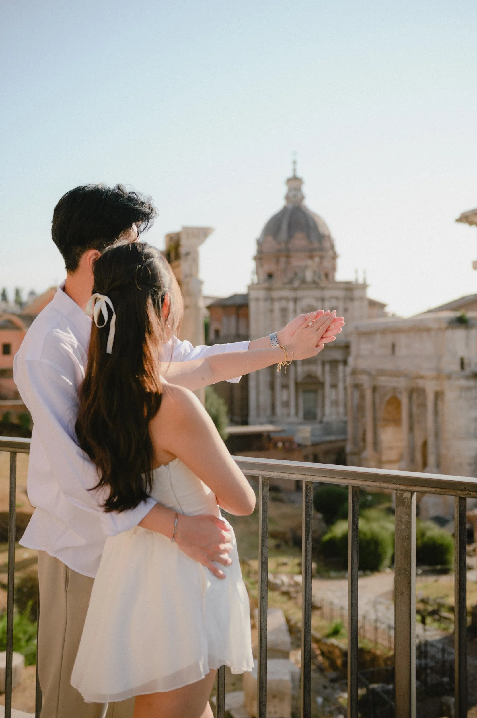 Romantic engagement photoshoot in Rome with a city view capturing a candid intimate moment with a ring