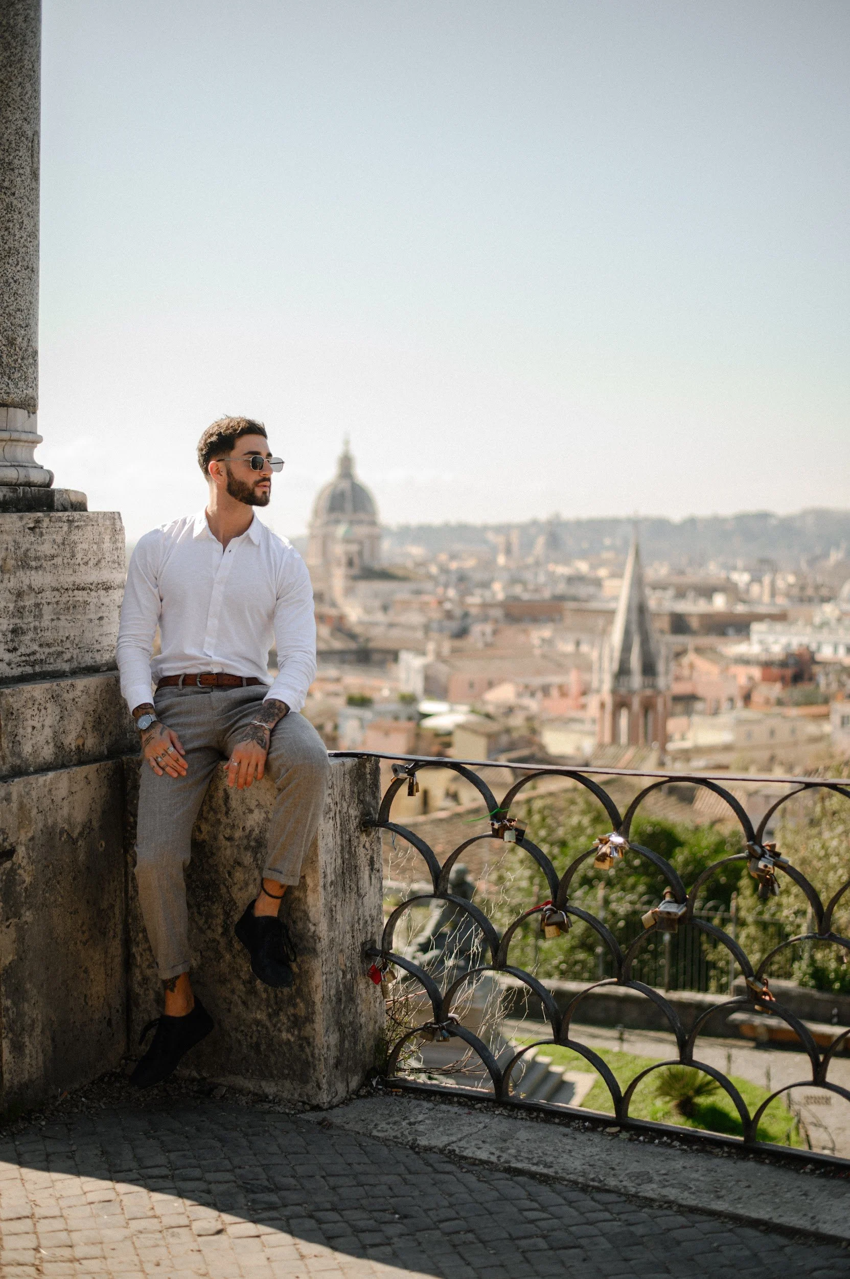 portrait in Rome of a man overlooking the city with a relaxed elegant mood
