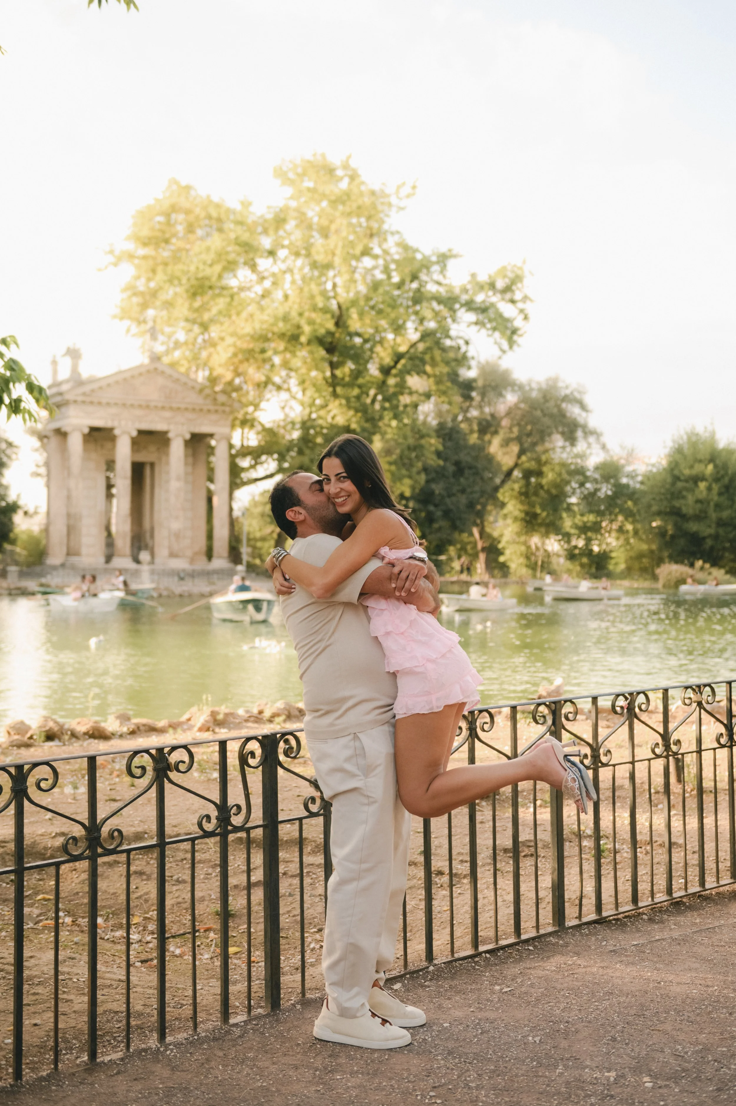 Romantic couple at Villa Borghese lake in Rome during proposal photoshoot