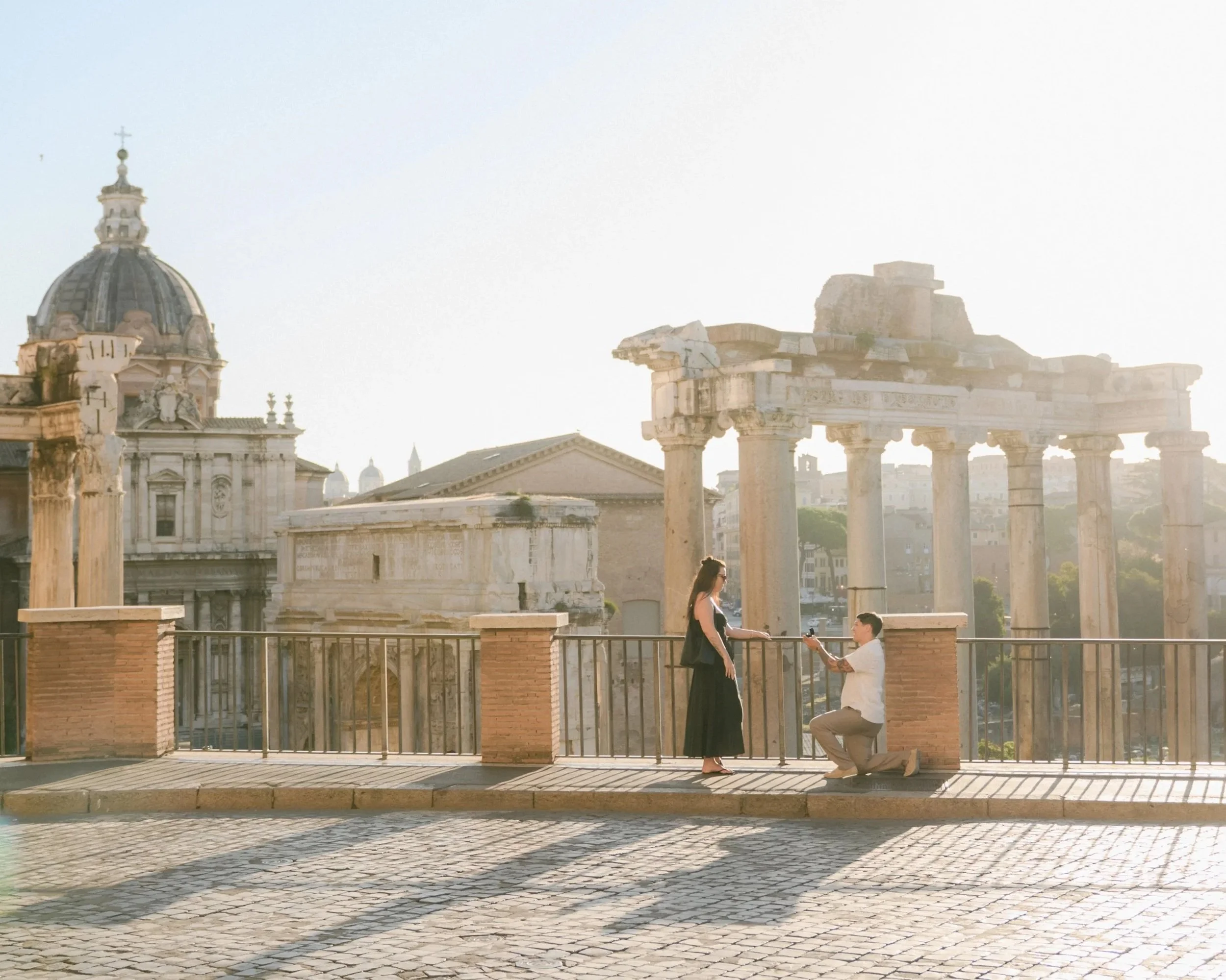 Surprise proposal in Rome at the Roman Forum during sunset.