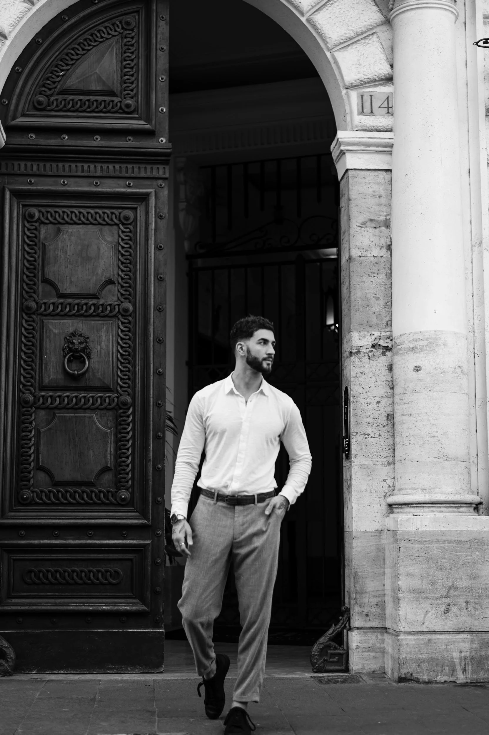 Candid moment in Rome of a man walking through historic streets in natural light