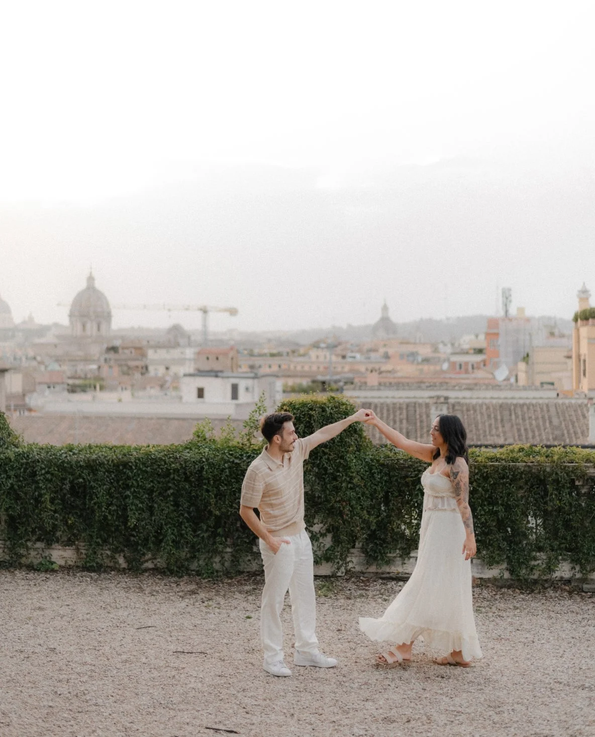Couple dancing together in Rome at sunrise, natural candid couple photoshoot