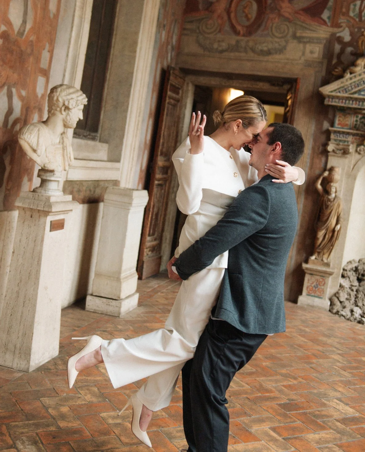 just engaged couple embracing in Palazzo Altemps Rome after proposal